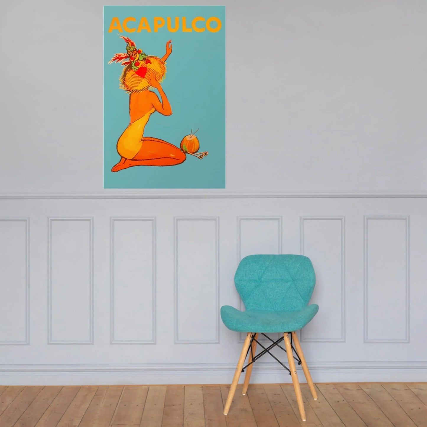 A turquoise chair sits by a light gray paneled wall and wooden floor. Above, Printful’s Acapulco reprinted vintage poster (24x36, premium luster paper) adds color with a bold orange nude, palm leaves, and vibrant ACAPULCO lettering.