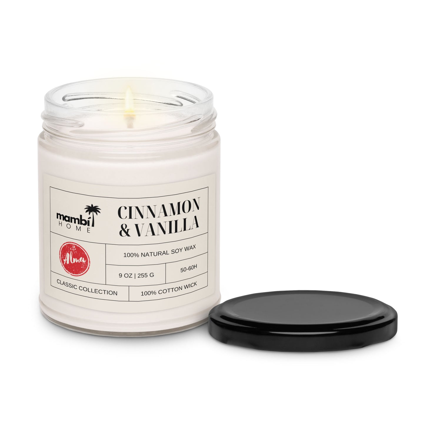 A lit white candle in a clear glass jar labeled Cinnamon & Vanilla with a black lid beside it. The label highlights that it’s one of our eco-friendly candles, made with 100% natural soy wax and a 100% cotton wick.