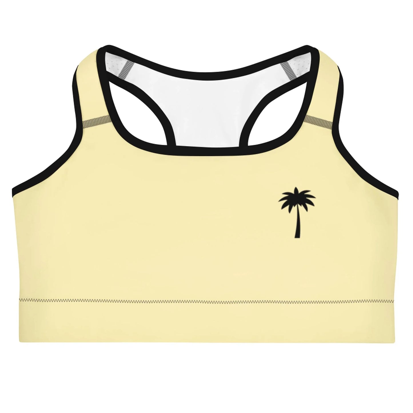 A light yellow Mambí sports bra with black trim and a small black palm tree graphic on the left side. It features a racerback design and visible stitching along the bottom edge.