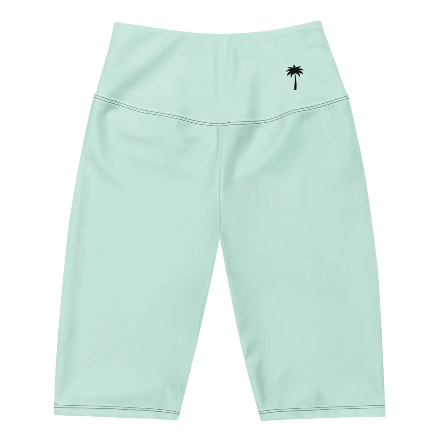 Light green, high-waisted, knee-length athletic shorts featuring a small black palm tree graphic on the waistband’s left side. These Mambí shorts have smooth fabric and visible stitching.