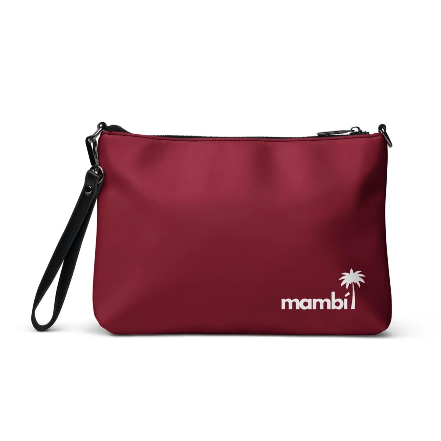 The Blake Crossbody Bag by Printful is a maroon faux leather clutch with a black wrist strap, featuring “mambi” and a white palm tree graphic printed in the bottom right corner.