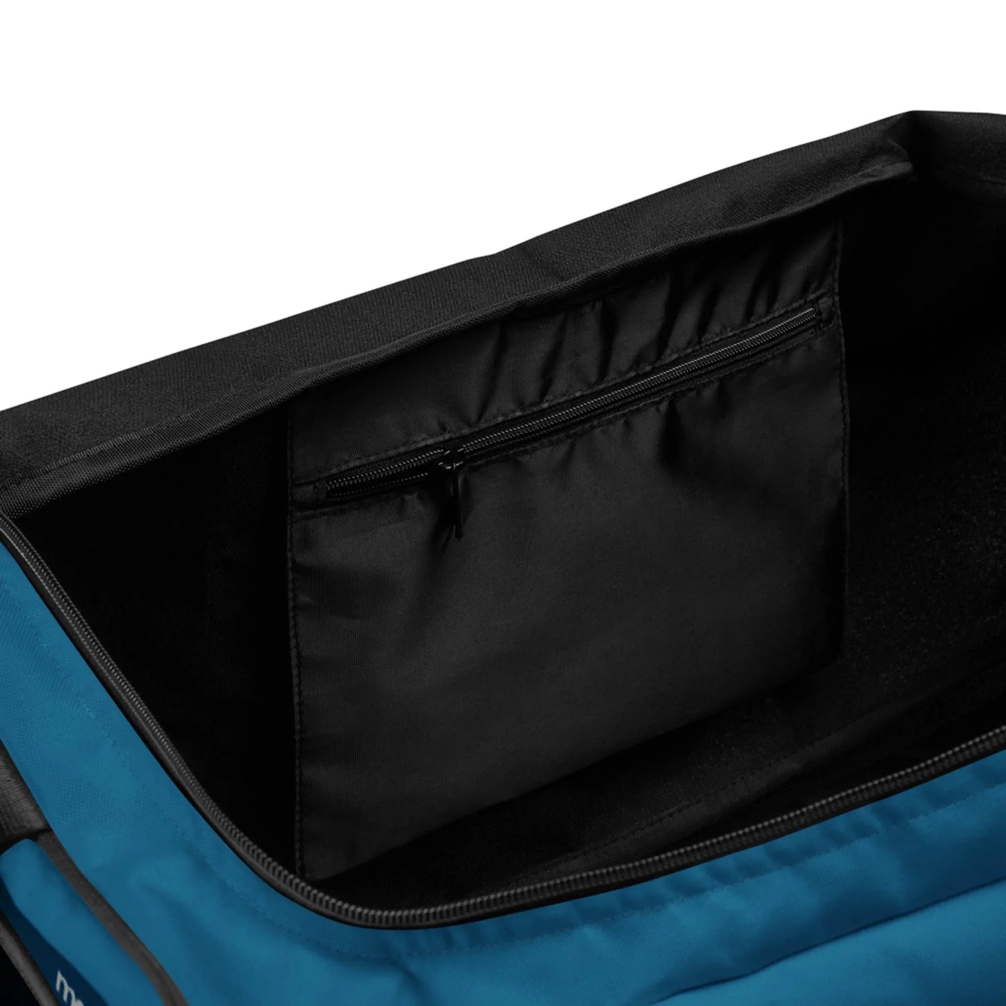 The image shows the interior of a Mambí blue bag with a black lining. A zippered pocket on the inside wall offers extra storage space, and the bag appears to be partially open.