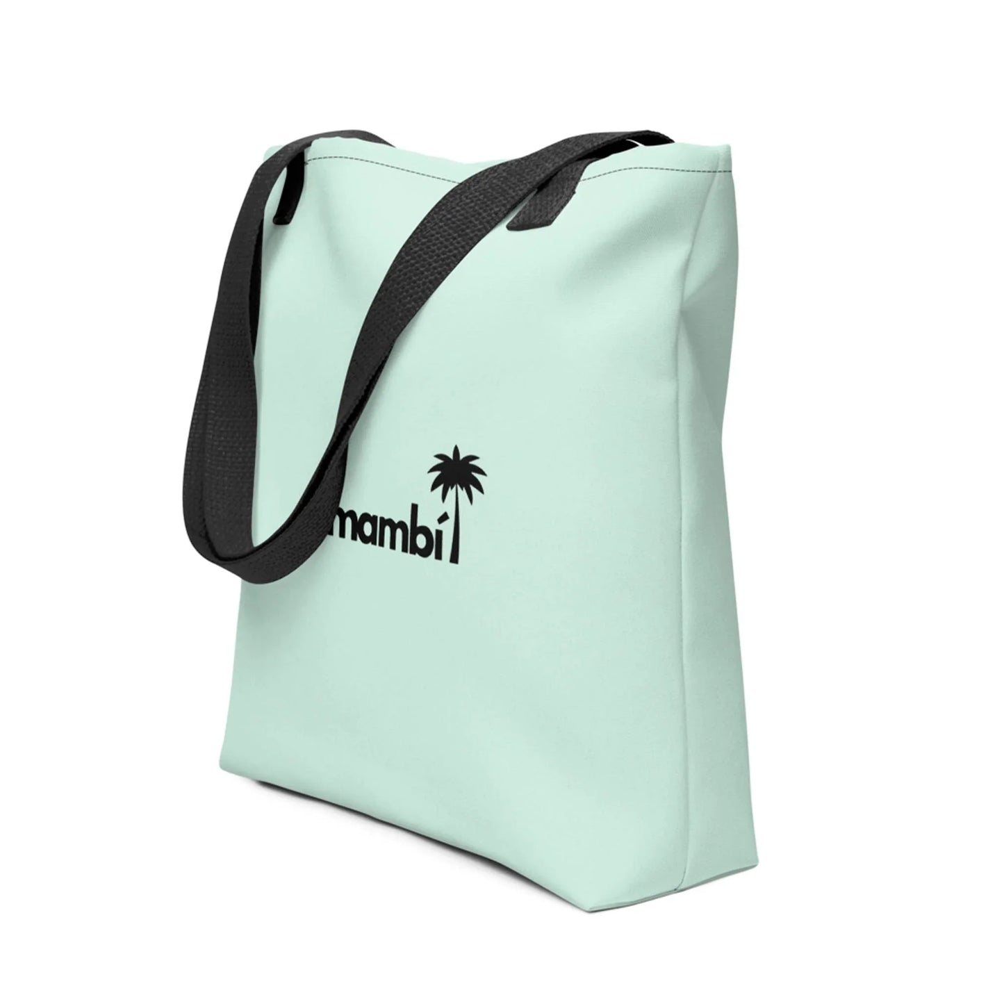 A light pastel green tote bag with black straps, featuring a black palm tree graphic and the word Mambí on the front. The tote stands upright at an angle against a white background.