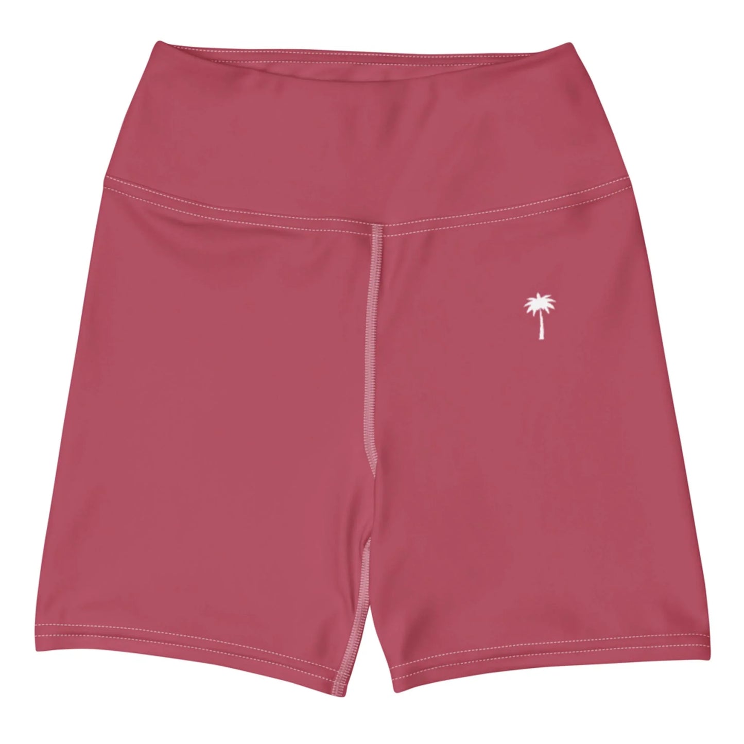The Printful Brickell Yoga Shorts for women are high-waisted pink shorts featuring a high waistband, visible white seam stitching, and a small white palm tree graphic on the left thigh.