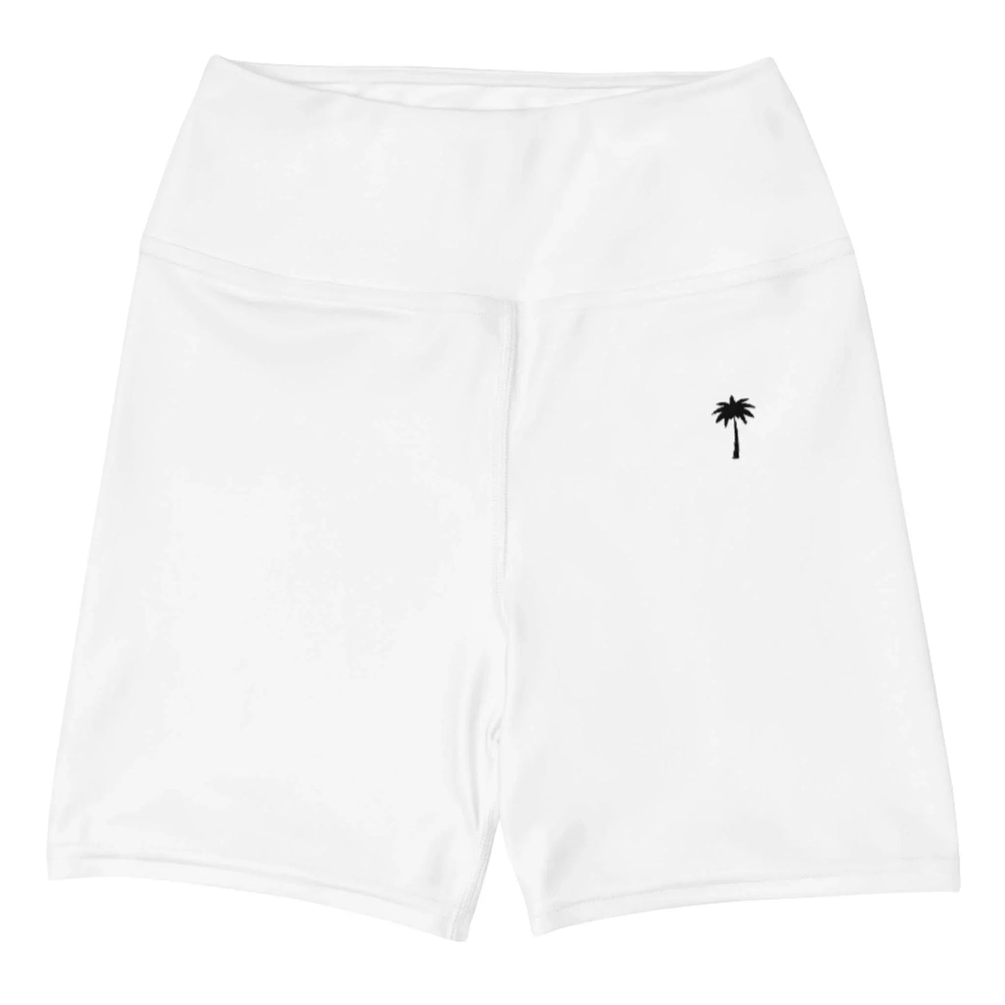 The Brickell Yoga Shorts for women by Printful are white, high-waisted, and feature a small black palm tree graphic near the waistband. Made from four-way stretch fabric, they are shown laid flat on a white background.