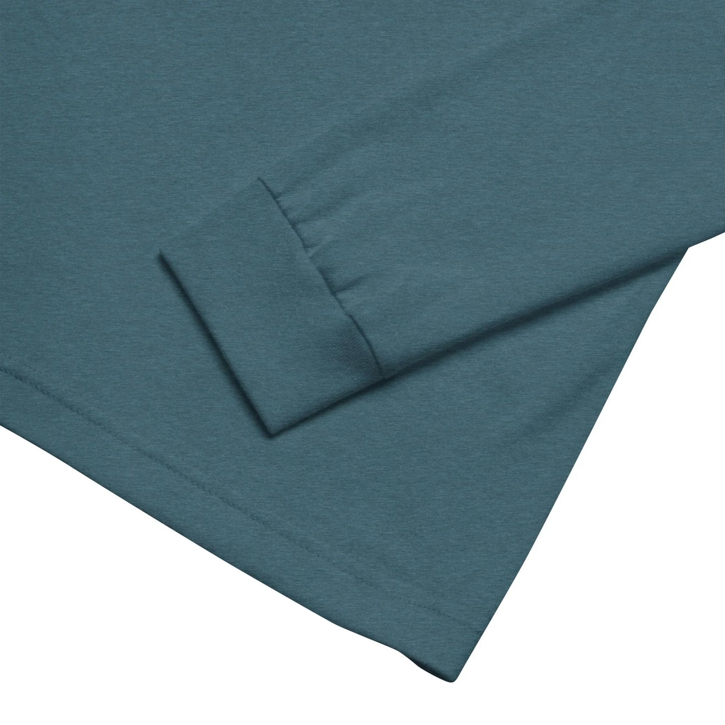 A close-up of a Mambí long-sleeve shirt in teal, highlighting the cuff and part of the sleeve laid flat on a white background.