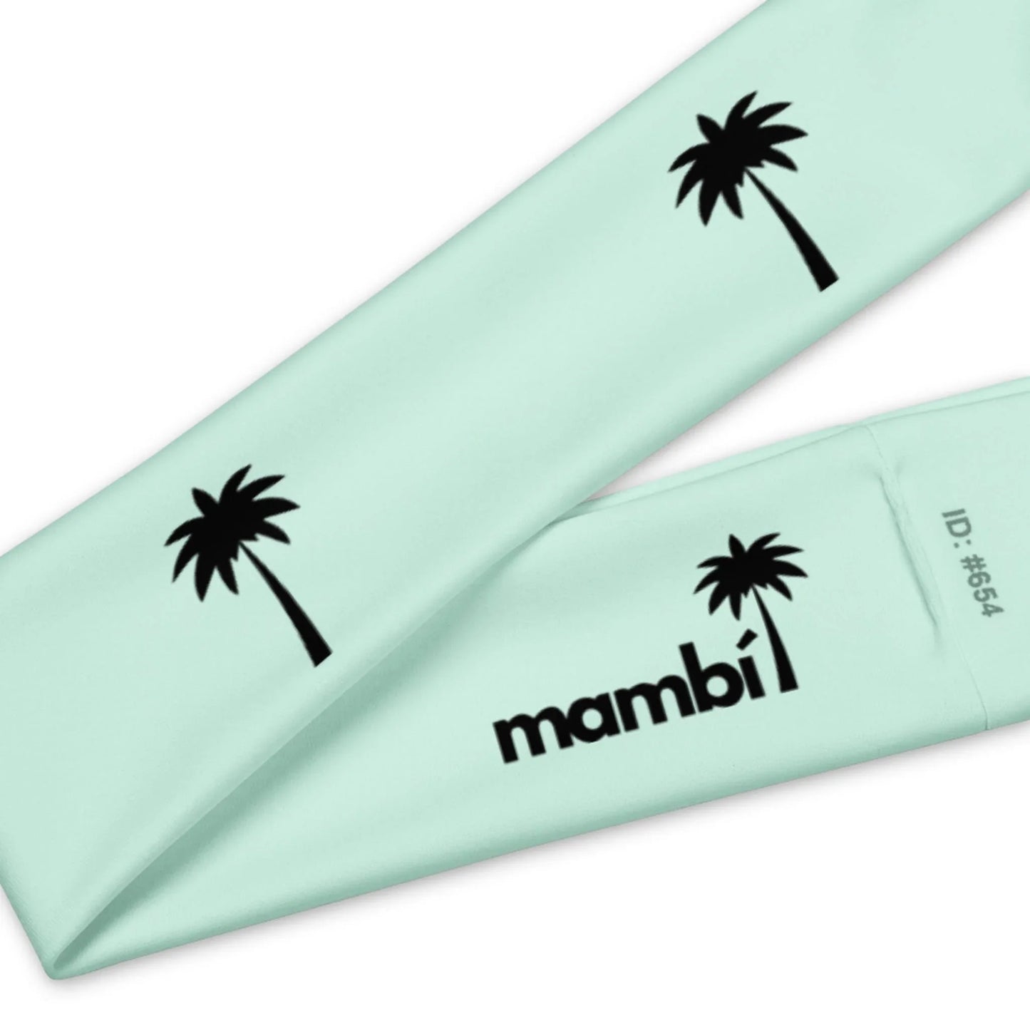 A light blue fabric band featuring black palm tree graphics and the word Mambí printed in black, with ID: #654 on one end.