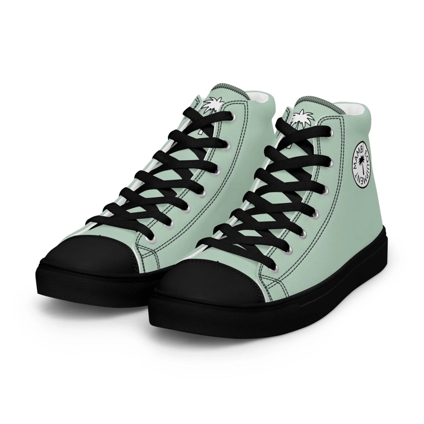 A pair of light green high-top sneakers with black soles, black laces, and black toe caps. The shoes feature a round Mambí logo with palm trees on the ankle area and tongue.