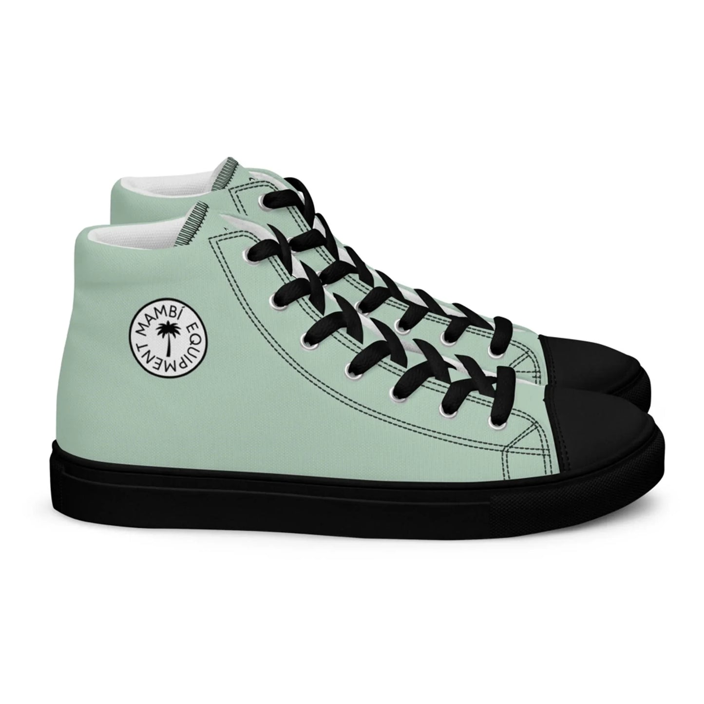 A pair of mint green high-top sneakers with black soles, black toe caps, and black laces. A circular Mambí logo on the ankle area features the words MAMBI EQUALITY EMPOWERMENT.