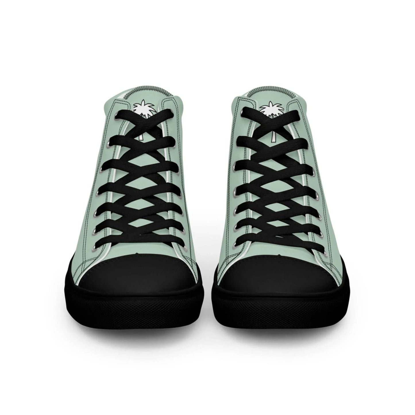 A pair of high-top Mambí sneakers with light green sides, black laces, black toes and soles, and a white palm tree graphic on each tongue, shown from the front against a white background.