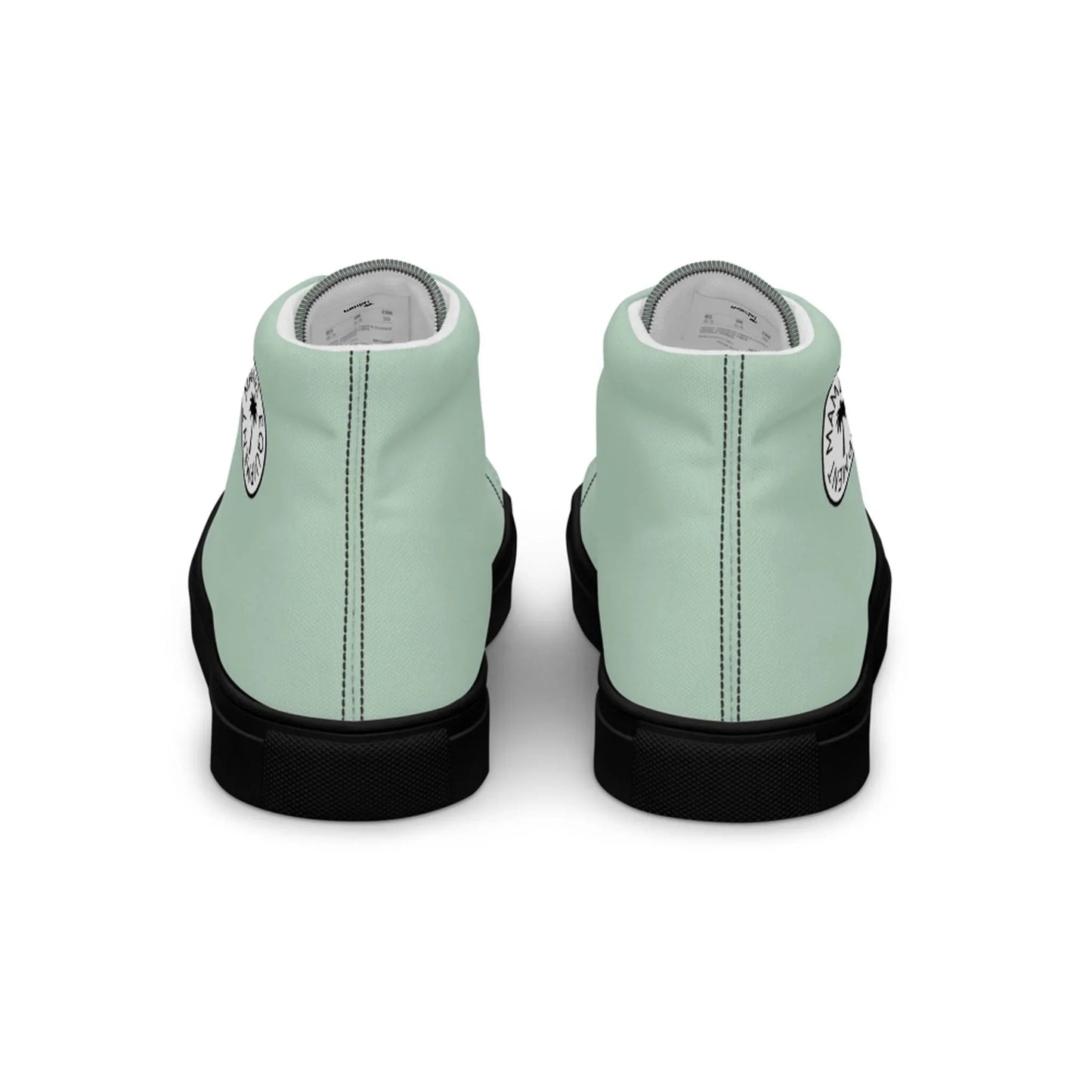 A pair of mint green Mambí high-top sneakers with black soles, shown from the back. Each shoe features a circular white and black logo near the heel.