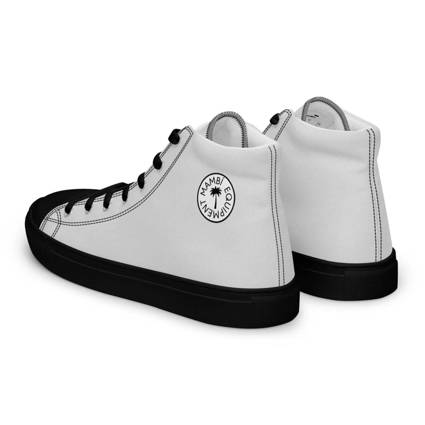 A pair of white high-top sneakers with black soles and black laces. The shoes feature a circular Mambí logo with the words Mambo Empanemy and a palm tree graphic on the outer side near the ankle.