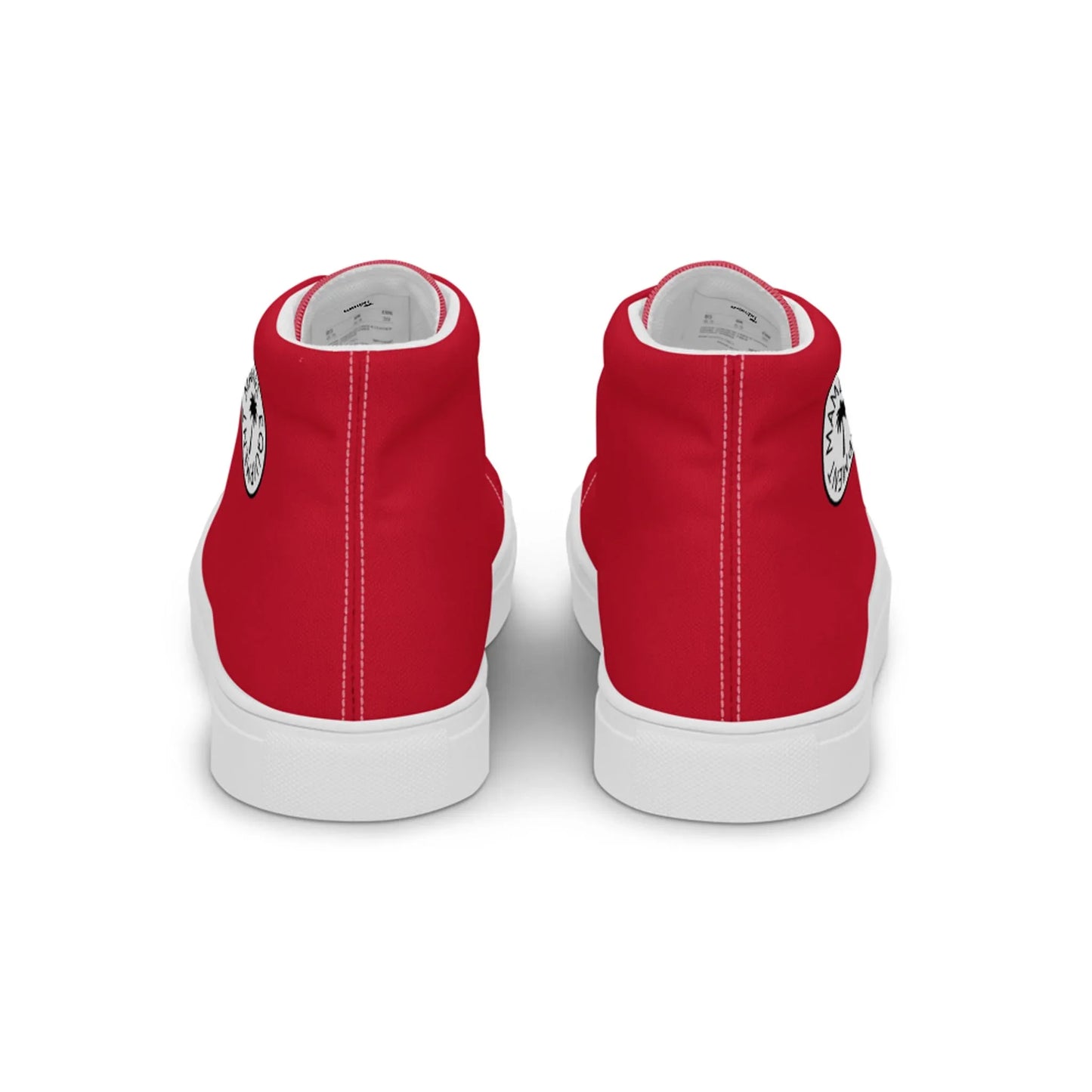A pair of red high-top sneakers viewed from the back, featuring white soles, a black circular logo on the outer side of each shoe, and subtle Mambí accents.