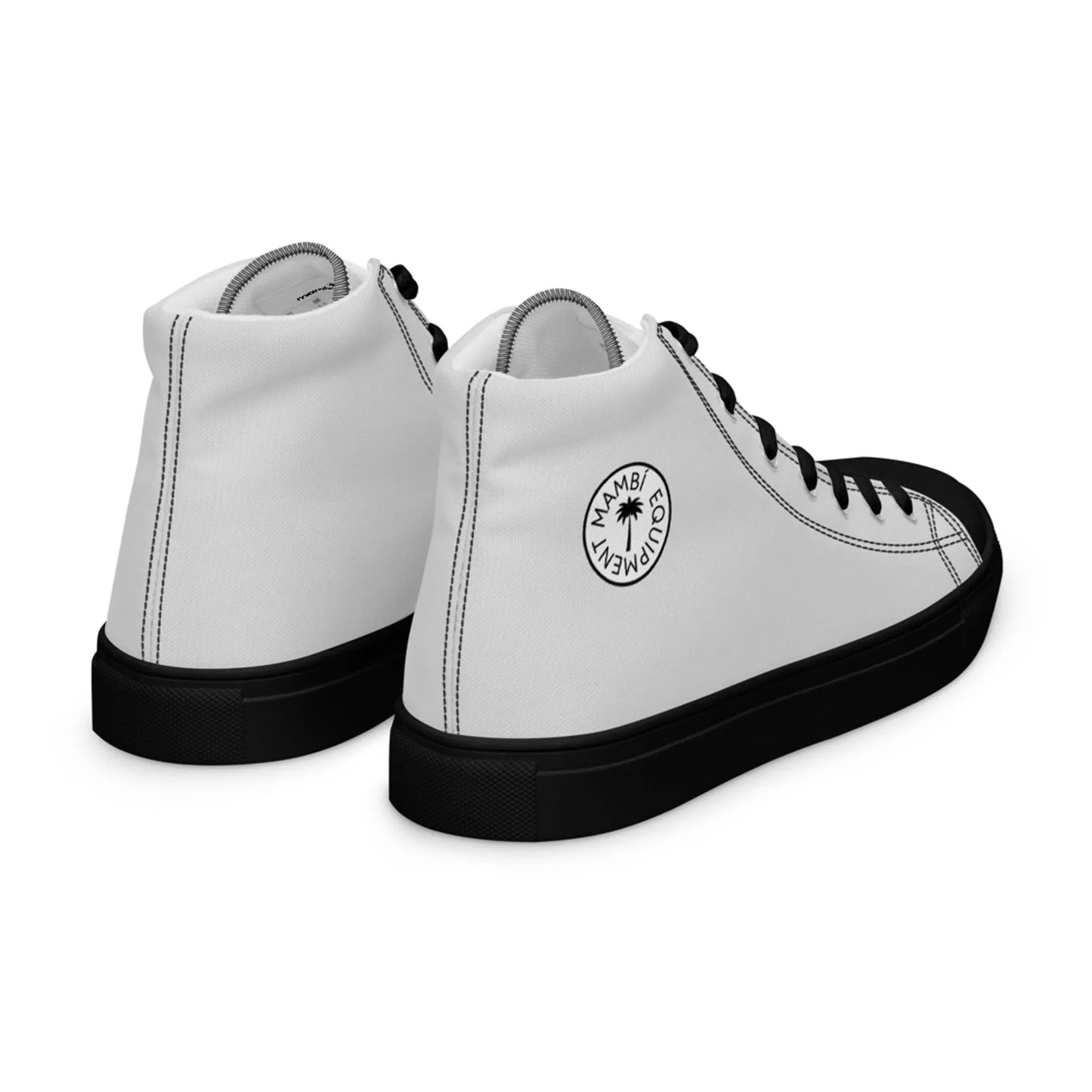 A pair of white high-top Mambí sneakers with black soles and laces, featuring a round black logo on the side that says Mambi Movement around a palm tree graphic. The shoes are positioned to show the back and side.