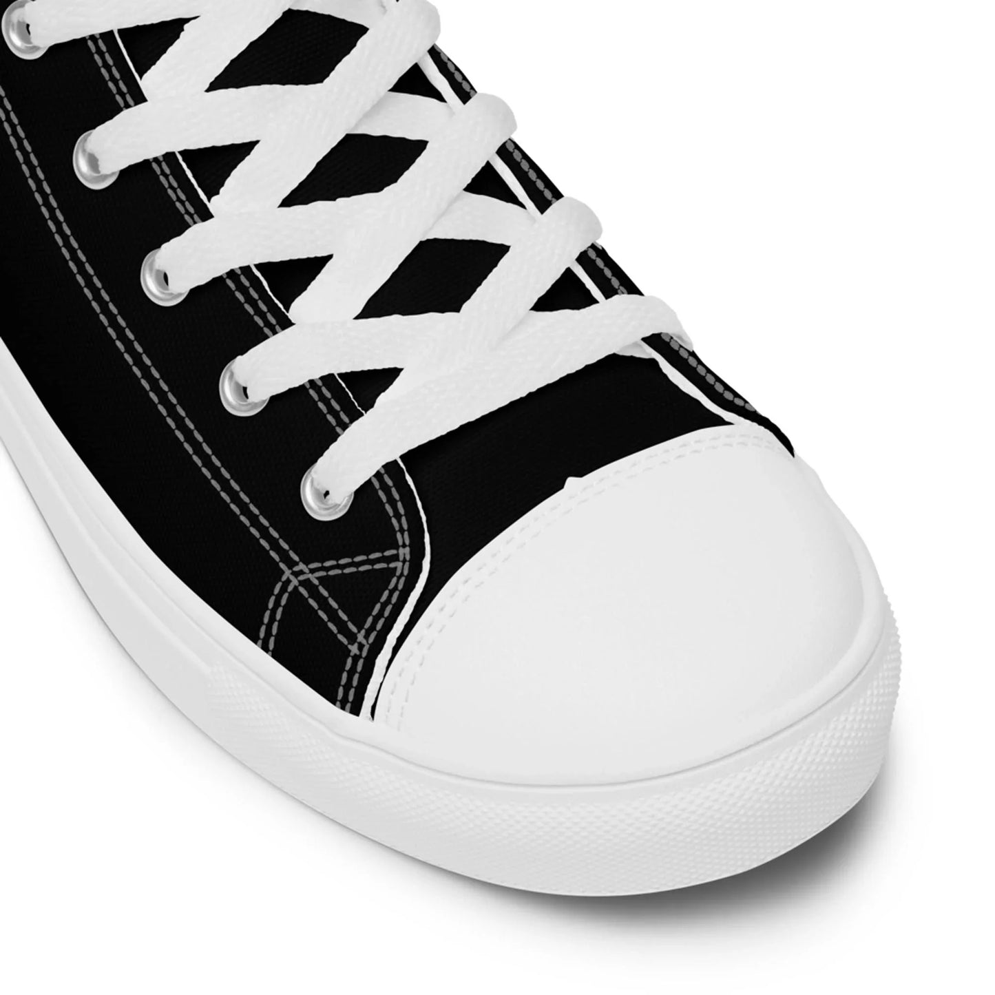 A close-up of the Carlito Sastre Vintage Hi-Top Sneakers by Printful for women in white/black, featuring white laces, stitching, and a rubber toe cap and sole. The shoe is angled from above, displaying its side and front.