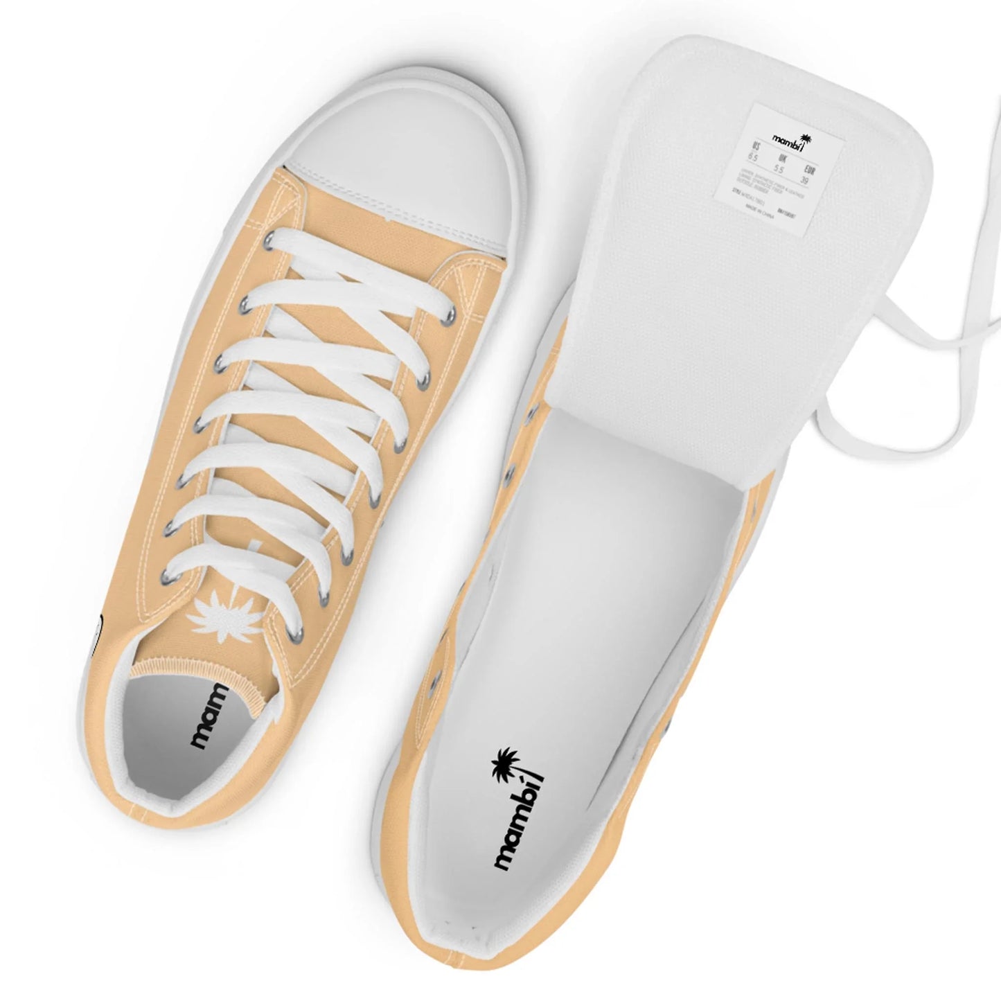 Two peach-colored canvas sneakers with white rubber toes and laces are shown. One shoe is upright, the other is on its side with the tongue lifted, displaying the shoe label and Mambí logo inside.