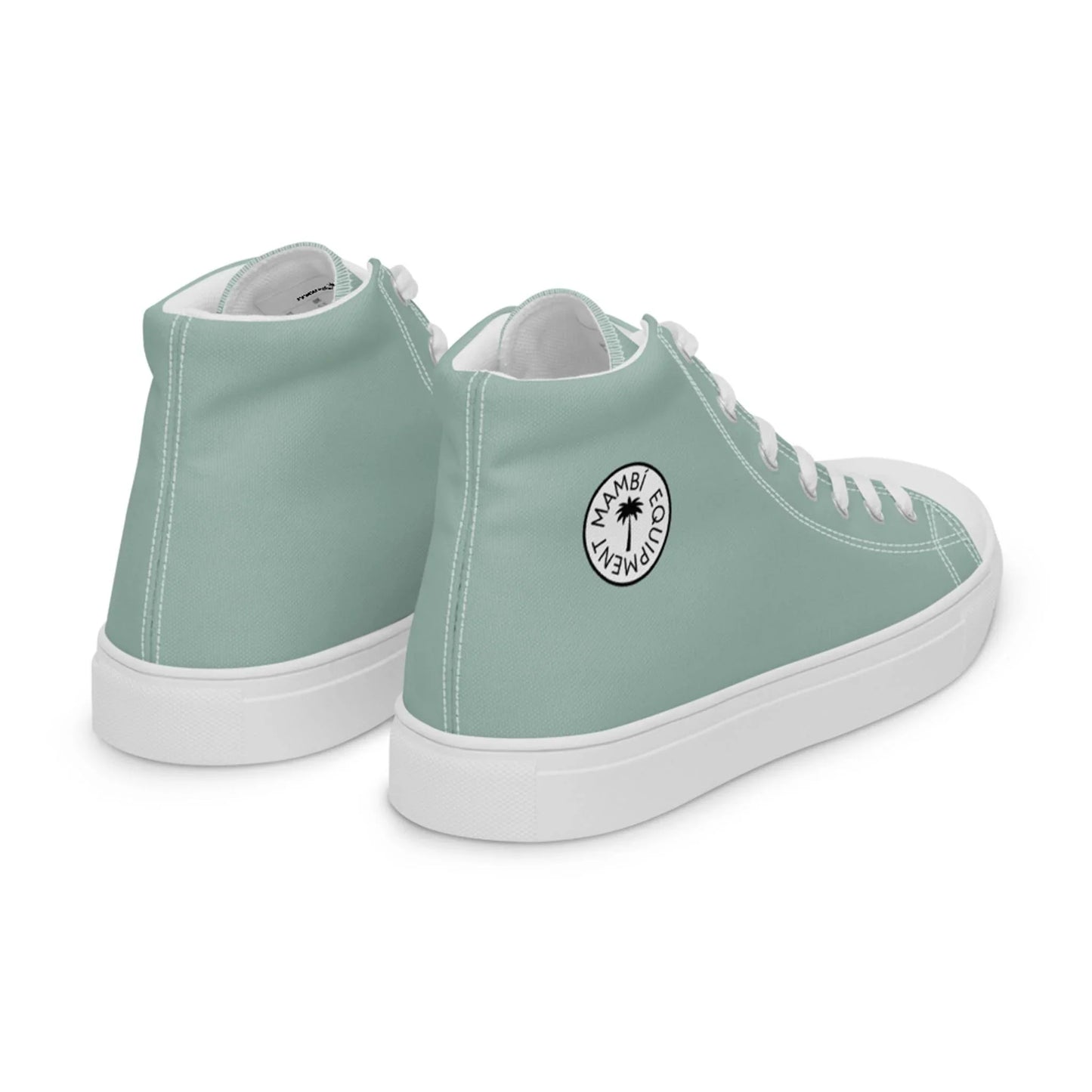 Two mint green high-top sneakers with white soles, white laces, and a round white Mambí Gourmet logo featuring a palm tree on the side. The shoes are positioned at an angle, showing the back and outer side.