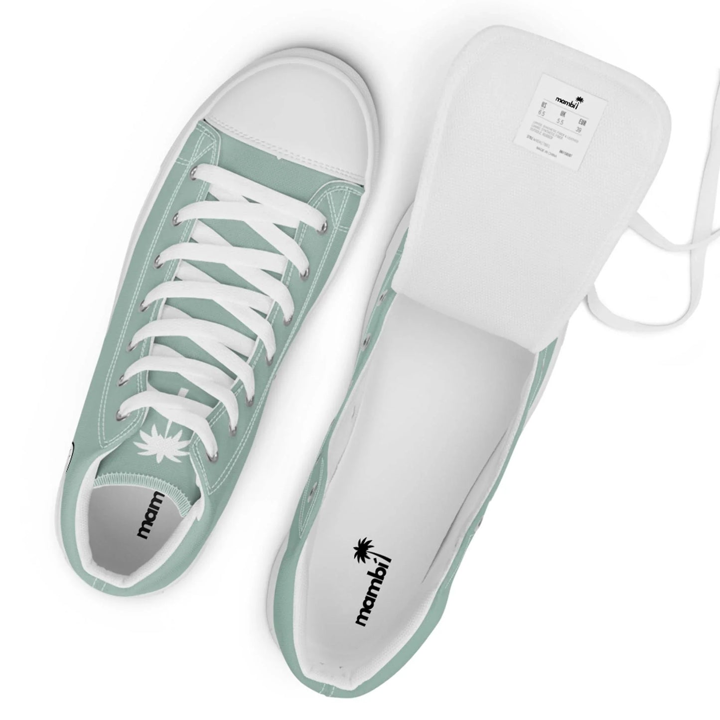 A pair of mint green Mambí low-top sneakers with white laces, white rubber toe caps, and white interiors. One shoe stands upright while the other rests on its side with the tongue pulled out to reveal the label.