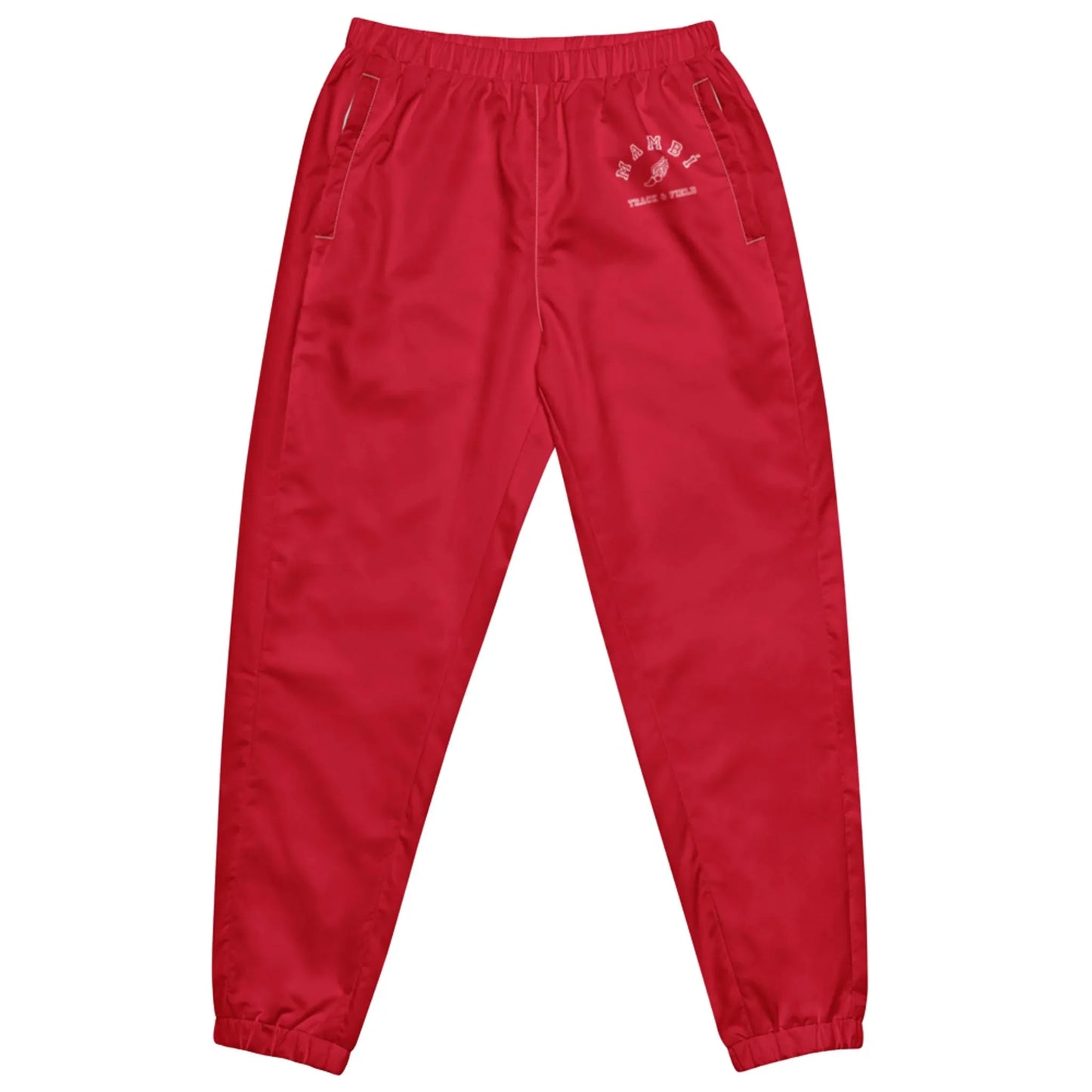Bright red Mambí jogger pants with an elastic waistband, side pockets, and elastic cuffs at the ankles. A small white graphic and text accents the left hip area.
