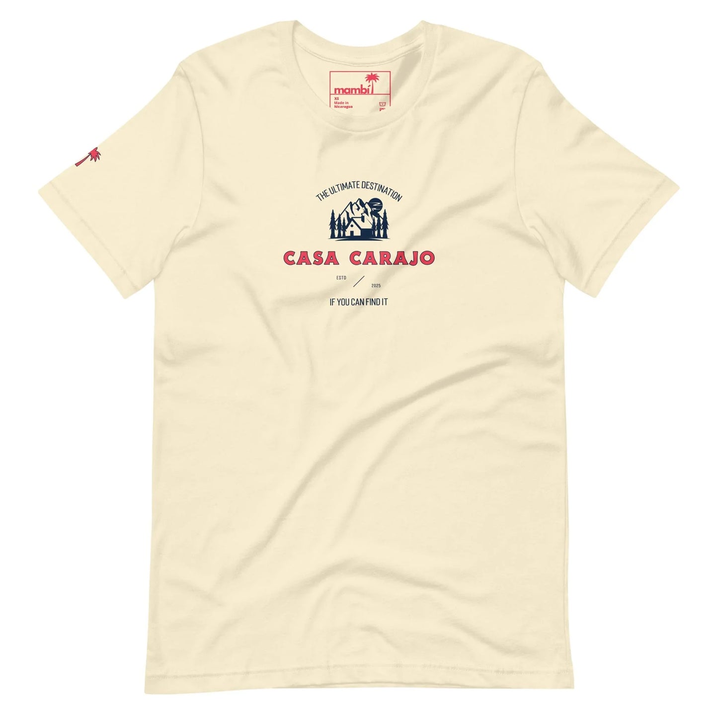 Cream-colored t-shirt featuring a blue and white house graphic, red palm tree logo on the sleeve, and bold red CASA CARAJO lettering with Mambí flair, topped by THE ULTIMATE DESTINATION in smaller text.