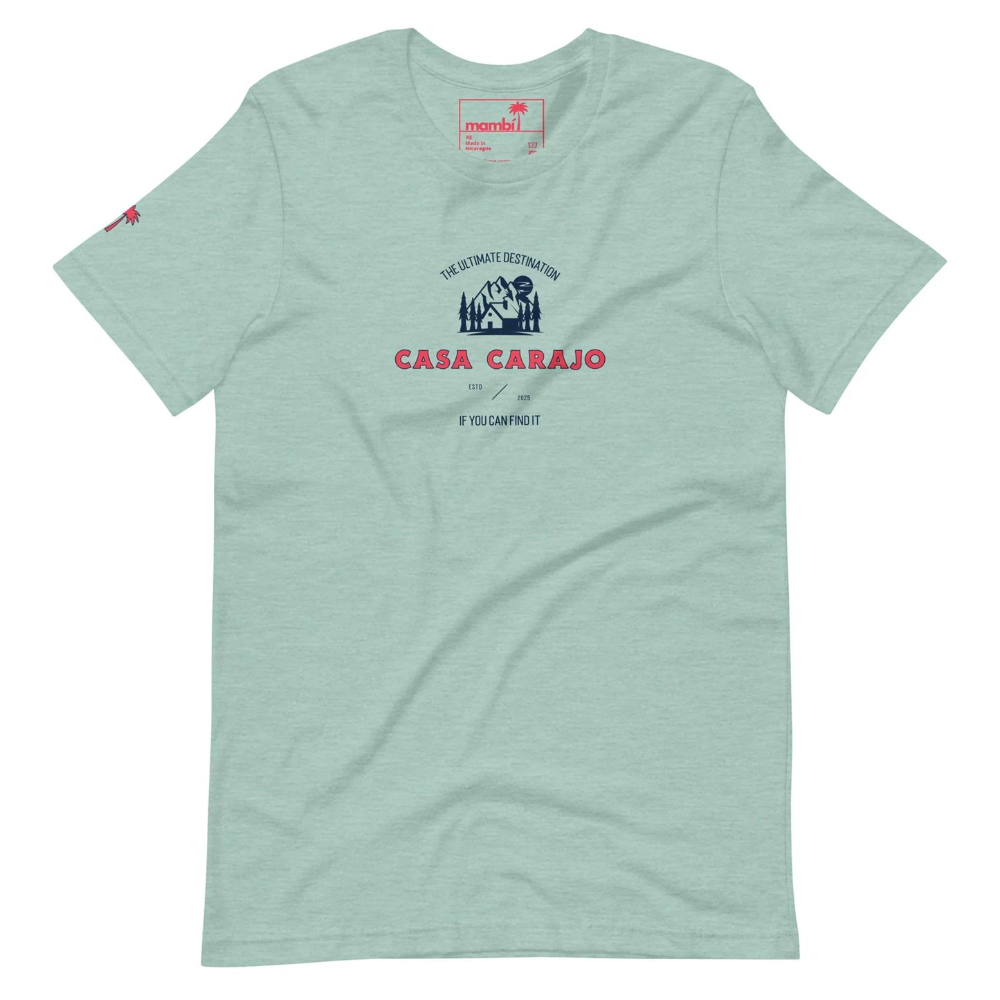 Light green Mambí T-shirt featuring a dark blue and red graphic with “Casa Carajo” text, smaller lettering above and below, and a small palm tree logo on the left sleeve.