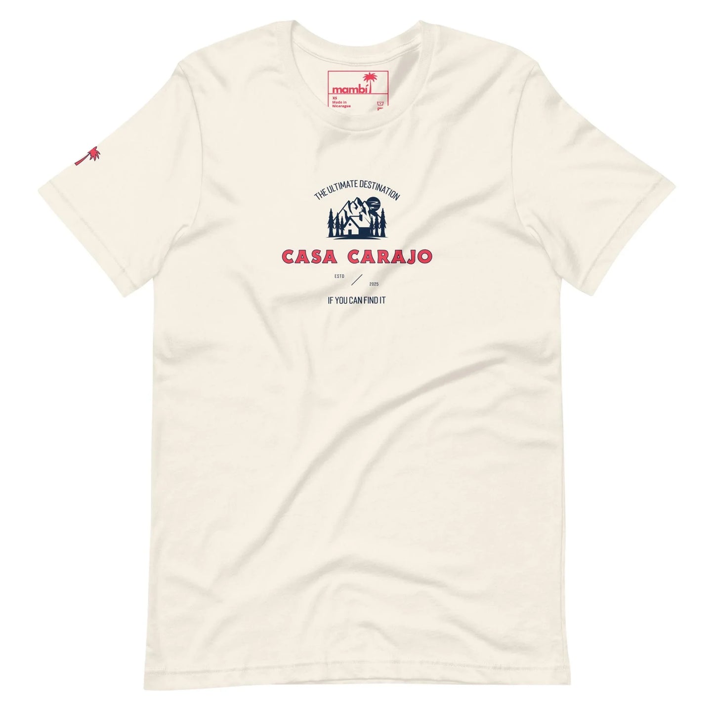 Off-white t-shirt featuring a small red palm tree on the left sleeve and a central graphic with a blue and red house illustration, reading Casa Carajo and If you cant find it, you cant do it—celebrating Mambí spirit.