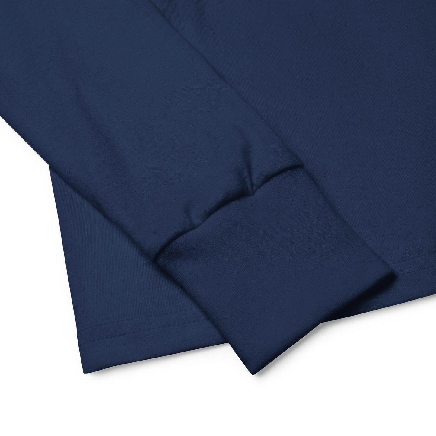 Close-up of the cuff and sleeve of a navy blue Mambí long-sleeve shirt, highlighting the neatly stitched hem and smooth cotton fabric.