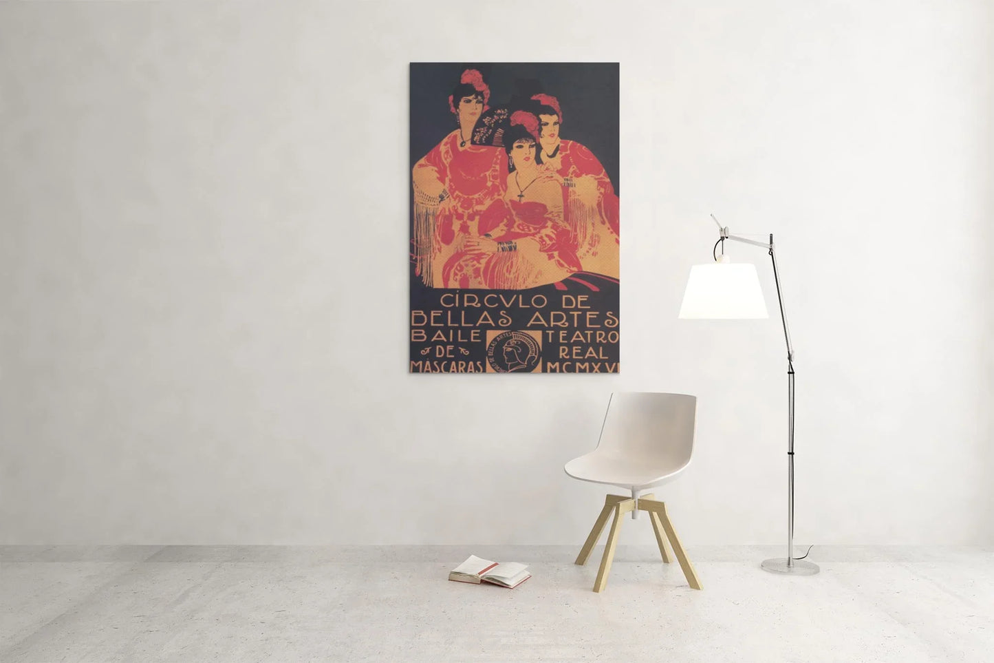 In a minimalistic room, a white chair and lamp sit beneath Printfuls Circulo de Bellas Artes vintage poster (24x36, premium luster paper), featuring three figures on a plain white wall.