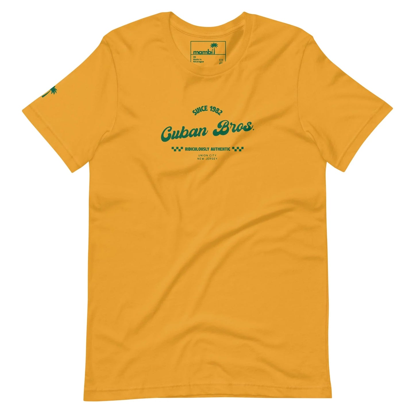 The Cuban Bros Graphic Tee by Printful is a unisex yellow shirt with green ‘Since 1982 Cuban Bros. Brooklyn, Authentic’ chest text and a palm tree graphic on the sleeve—ideal for entrepreneurs with laid-back style.