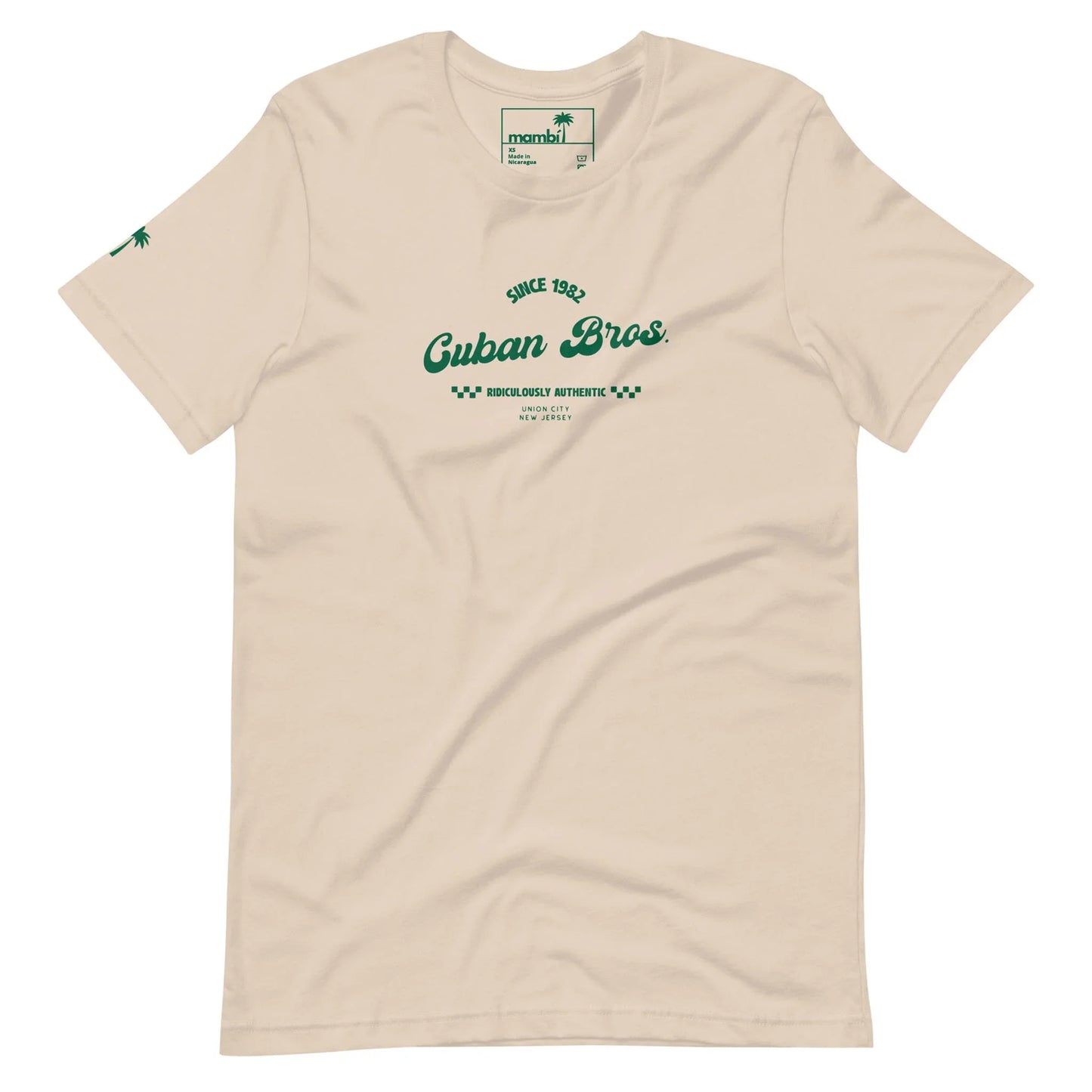 Printfuls unisex Cuban Bros Graphic Tee from the Neighborhood Collection features beige fabric, green “Since 1992 Cuban Bros. Brooklyns Authentic, New York City” chest text, and a small green palm tree on one sleeve—ideal for stylish entrepreneurs.