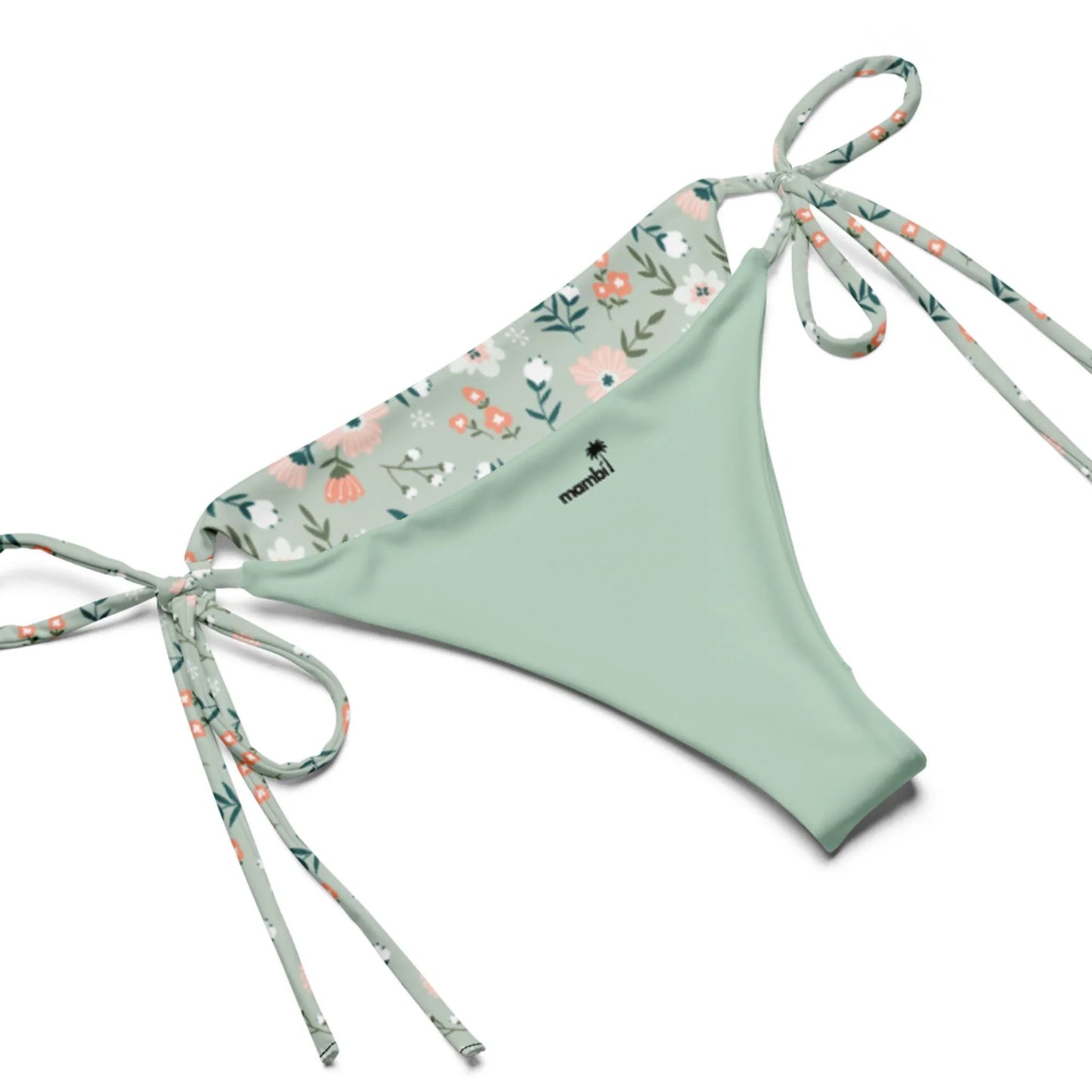 The Daniella String Bikini Swimsuit by Printful is a light green swimwear bottom with floral trim and side ties, crafted from recycled polyester. It features pastel flowers, leaves, and a black manihi logo on the front center.