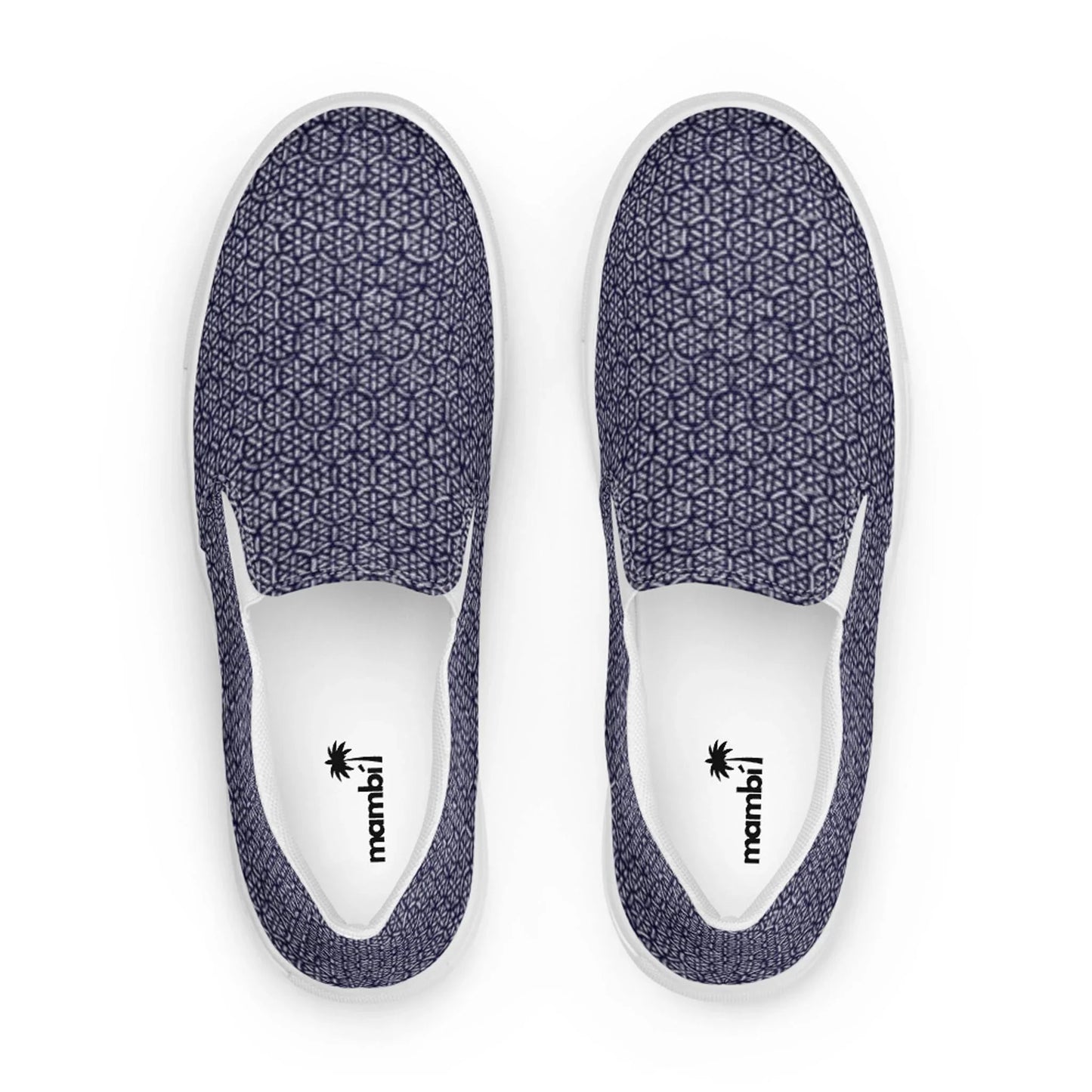 The Digno Handmade Slip-On Canvas Shoes for men by Printful feature a dark blue geometric pattern on canvas, white soles, and insoles branded with a black palm tree logo and mambil. Viewed from above.
