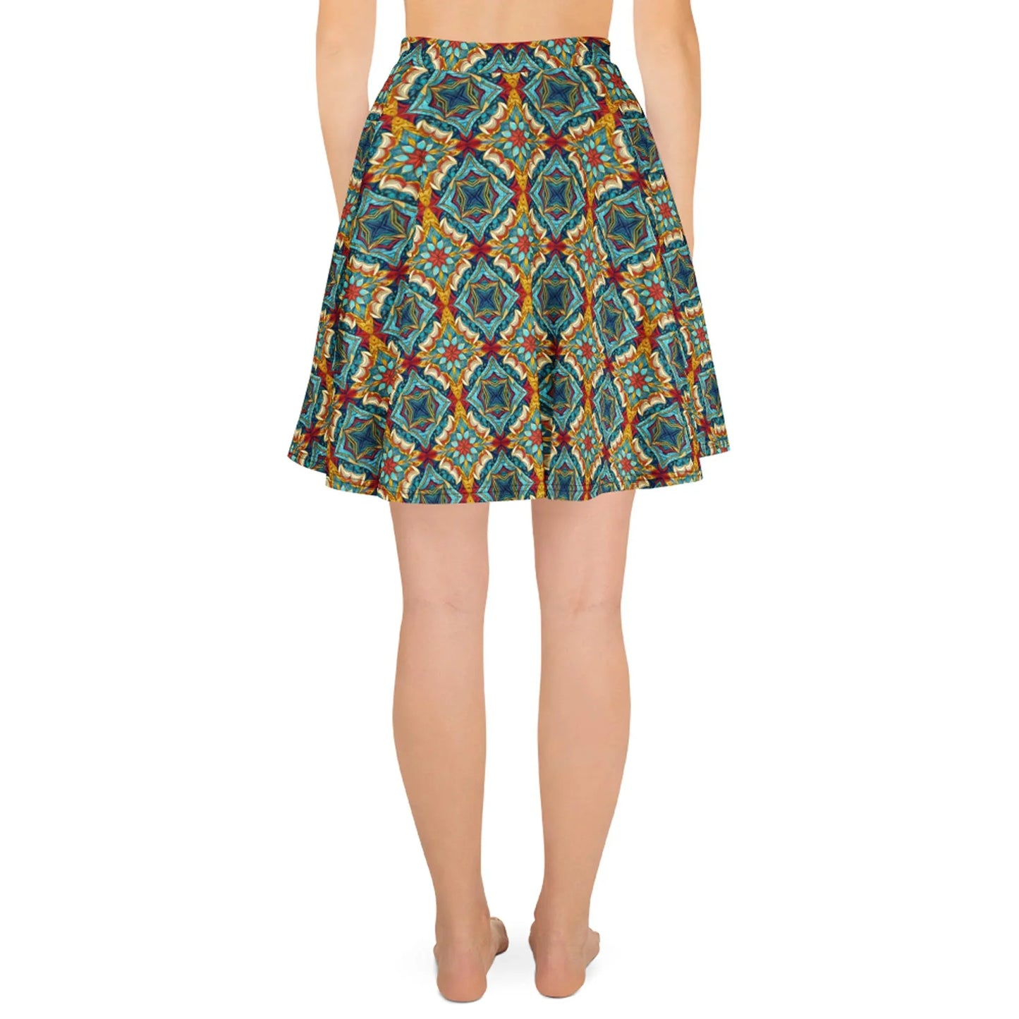 A person stands barefoot, facing away from the camera, wearing Printful’s Dinorah Skater Skirt—a knee-length women’s skirt with a geometric and floral pattern in blue, green, orange, and red, featuring an elastic waistband for a flattering fit.