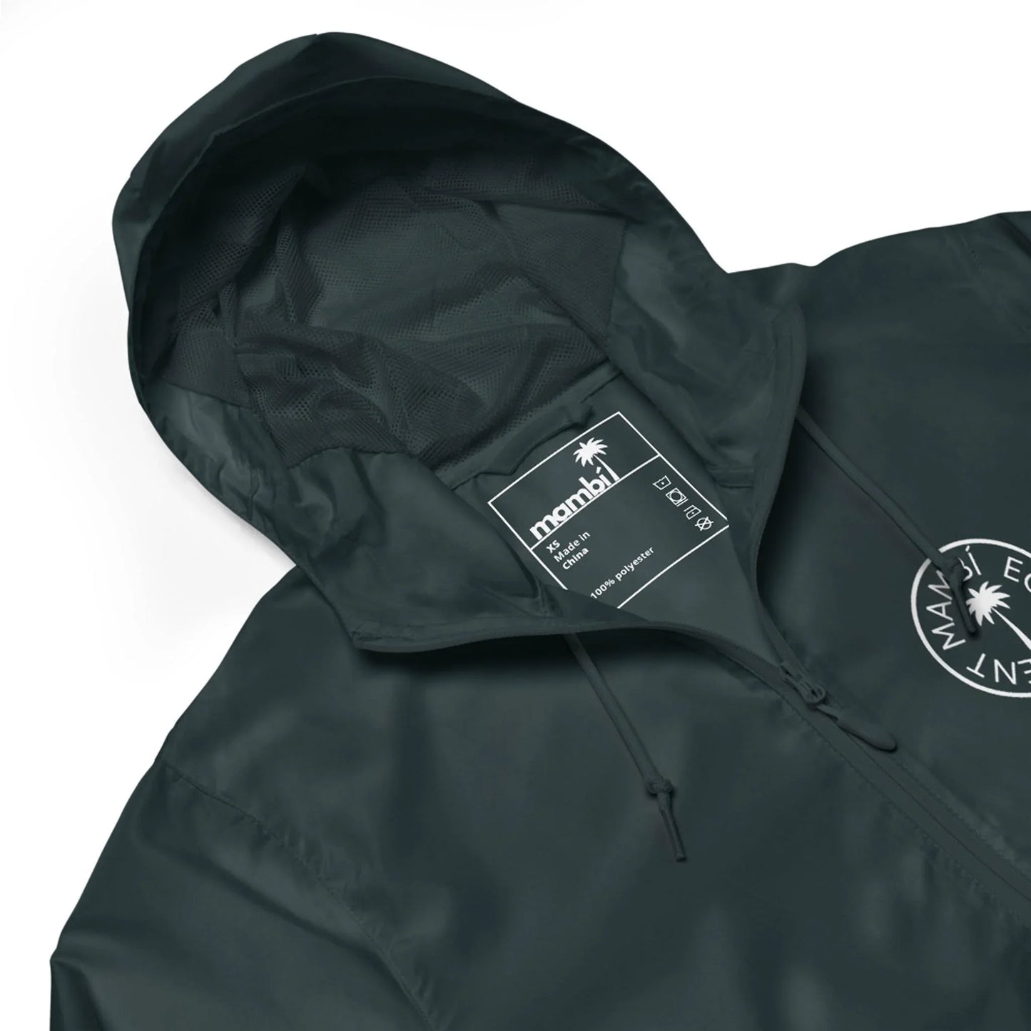 A dark green hooded jacket with a visible inner label that reads “manahi” and care symbols. The Mambí-inspired jacket features a circular white logo with a palm tree and text on the chest.