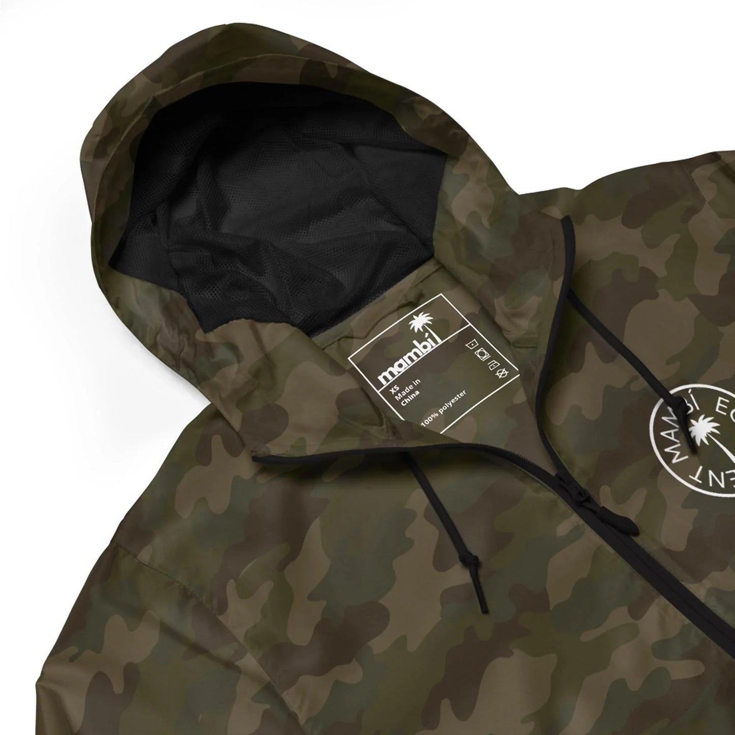 A close-up of a camouflage-patterned Mambí hooded jacket with black drawstrings. The jacket features a white palm tree logo and text on the left chest, along with a visible inside label reading manahi.