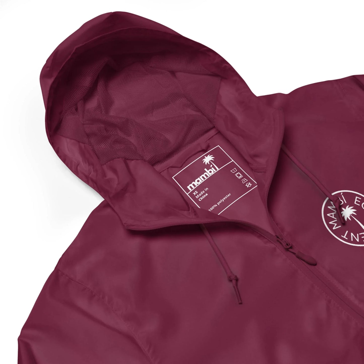 A maroon hooded jacket with a drawstring, featuring the Mambí manahi brand label inside the collar and a white palm tree logo on the left chest.