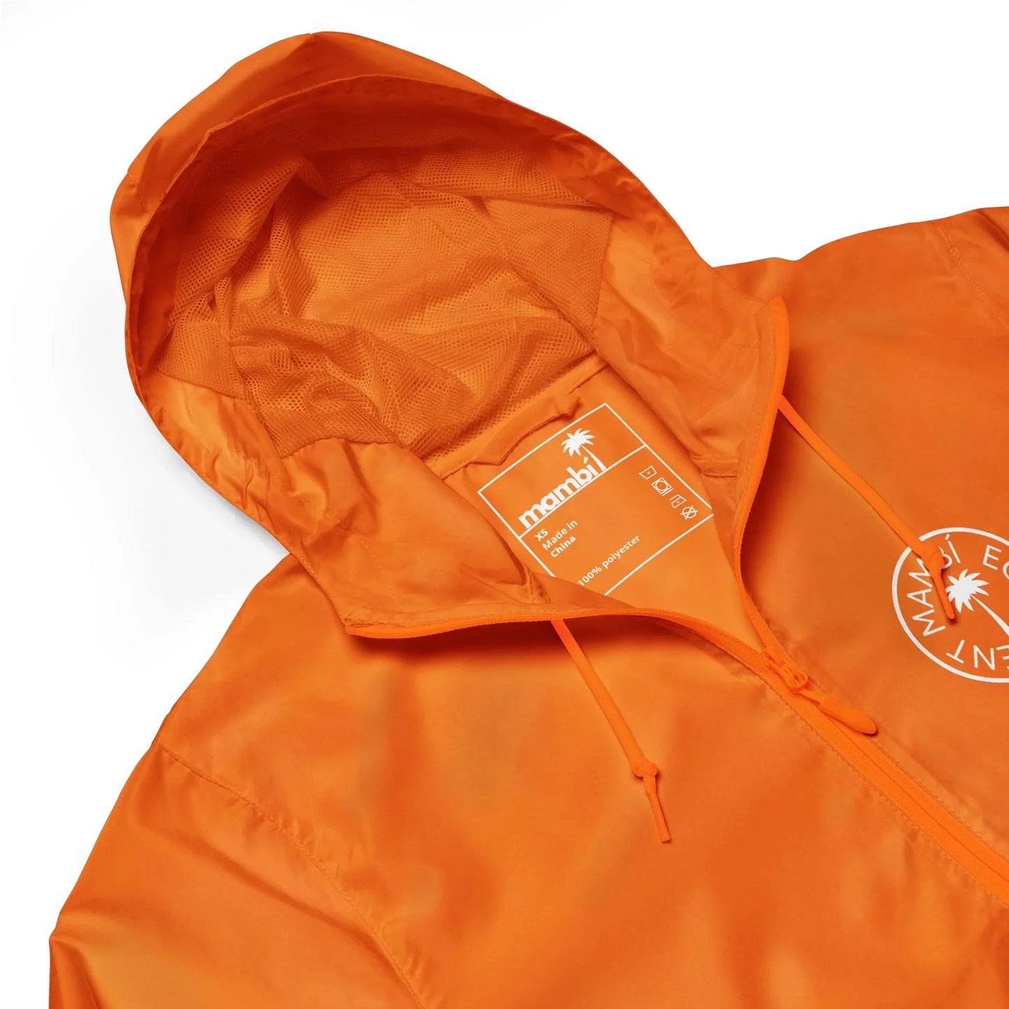 An orange hooded jacket with a drawstring, featuring a white printed Mambí logo and a visible inside tag that reads mandai. The jacket is laid flat on a white background.