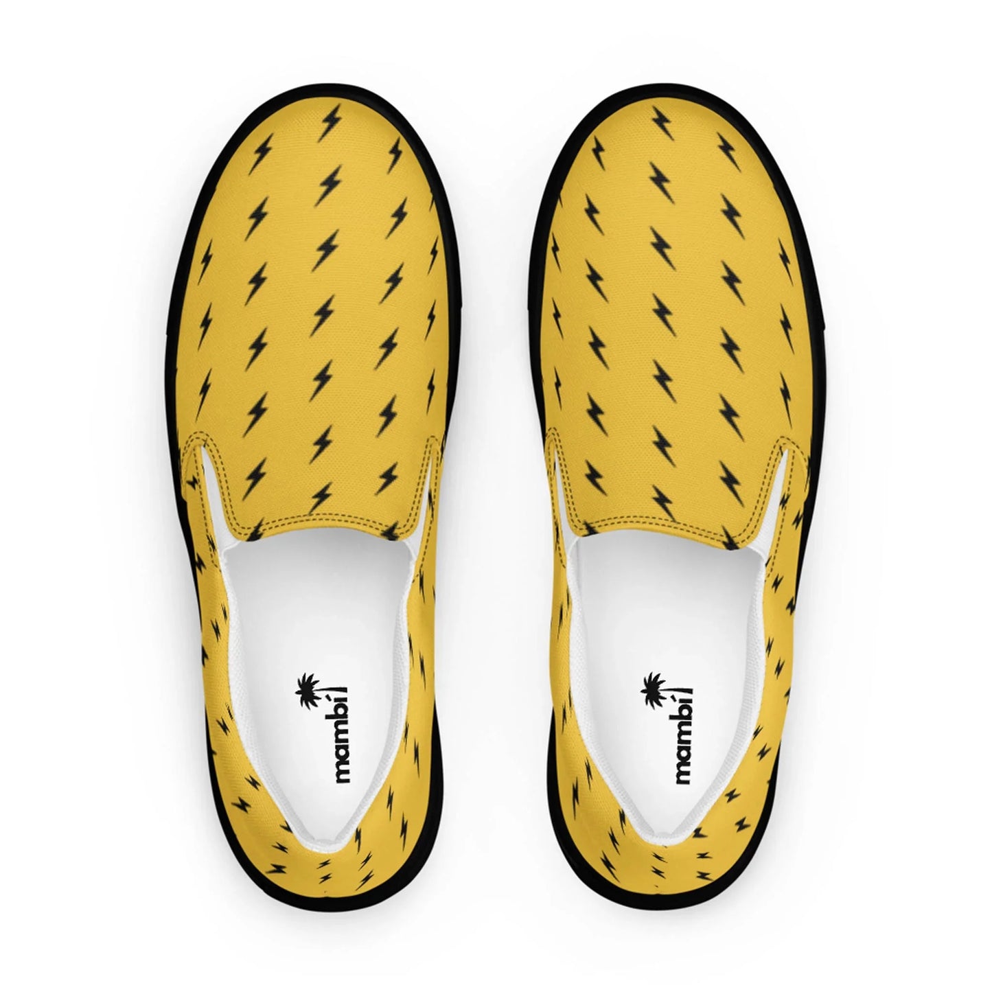 Top view of Electra Handmade Slip-On Canvas Shoes for men by Printful, featuring a bold black lightning bolt pattern, black sole edging, and a white inner lining with the mambú logo—handcrafted for standout style.