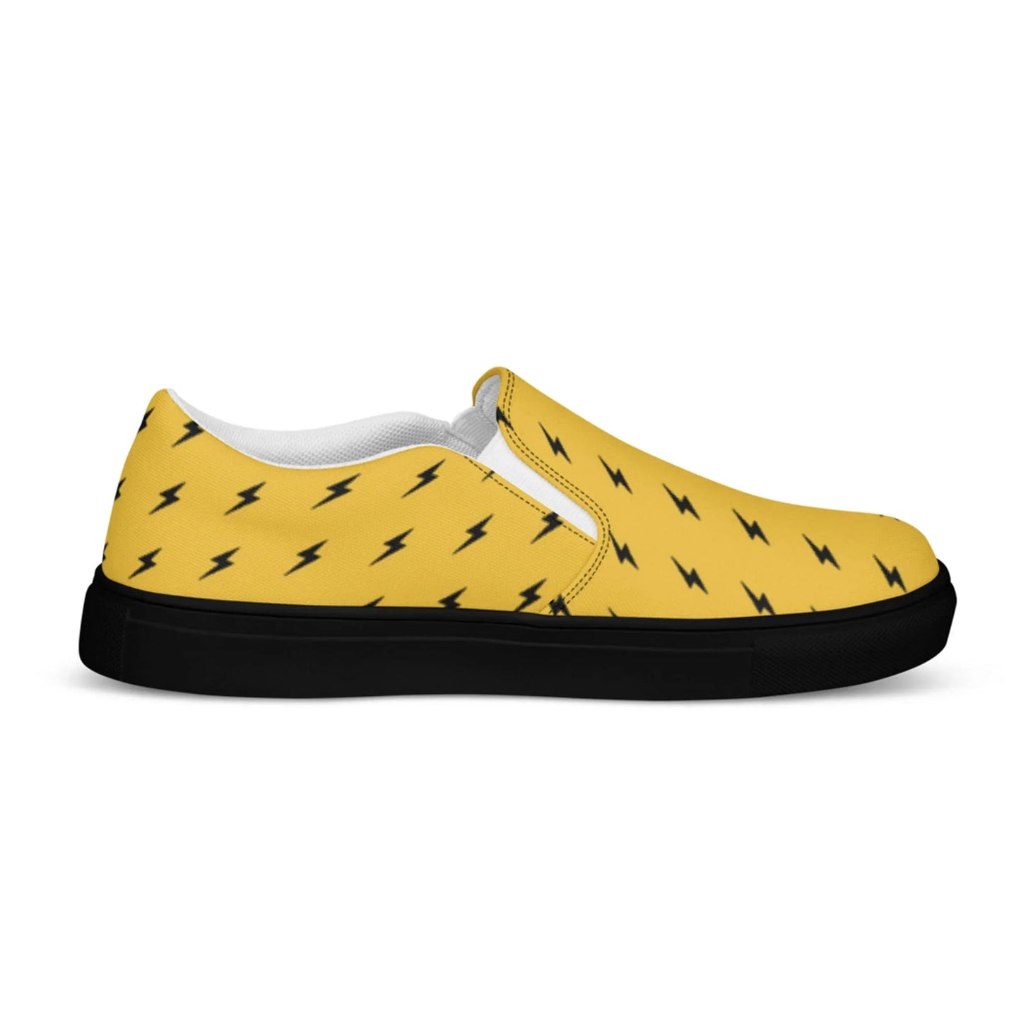 The Electra Handmade Slip-On Canvas Shoes for men by Printful feature a yellow canvas, black sole, white interior lining, and bold black lightning bolt pattern—a standout fashion statement in a comfortable slip-on design.