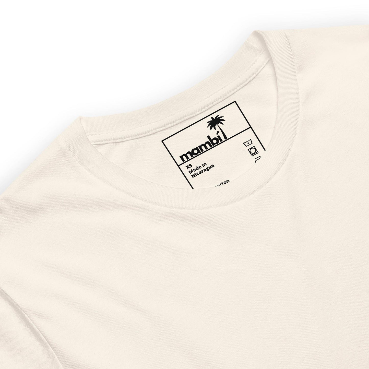 A close-up of the neck and collar area of a white t-shirt. The tag inside the shirt displays the Mambí brand with a small palm tree graphic and sizing details printed in black.