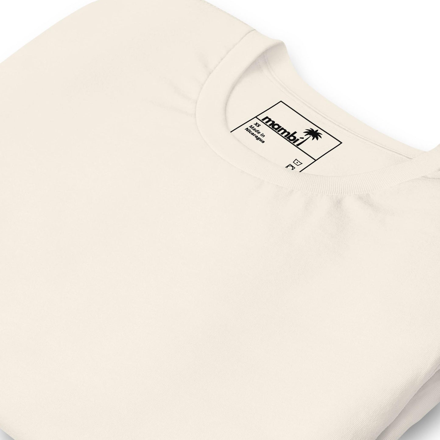 A close-up of a folded off-white crew neck t-shirt showcases the collar and inside label with the brand name “Arambi,” a small palm tree logo, and a subtle nod to Mambí style.