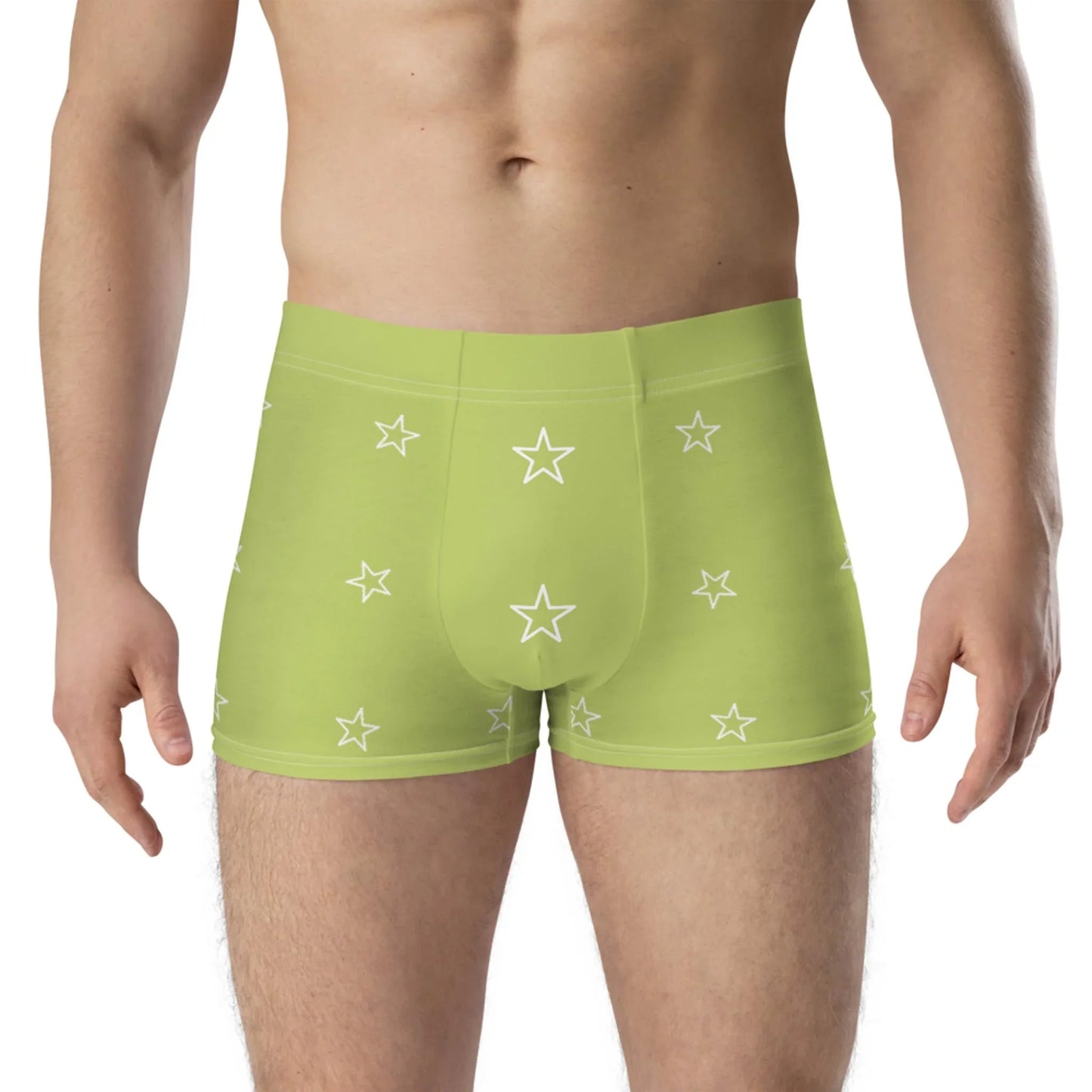 A person wearing light green Mambí boxer briefs decorated with white star patterns stands against a plain background. The image is cropped from mid-torso to upper thighs.
