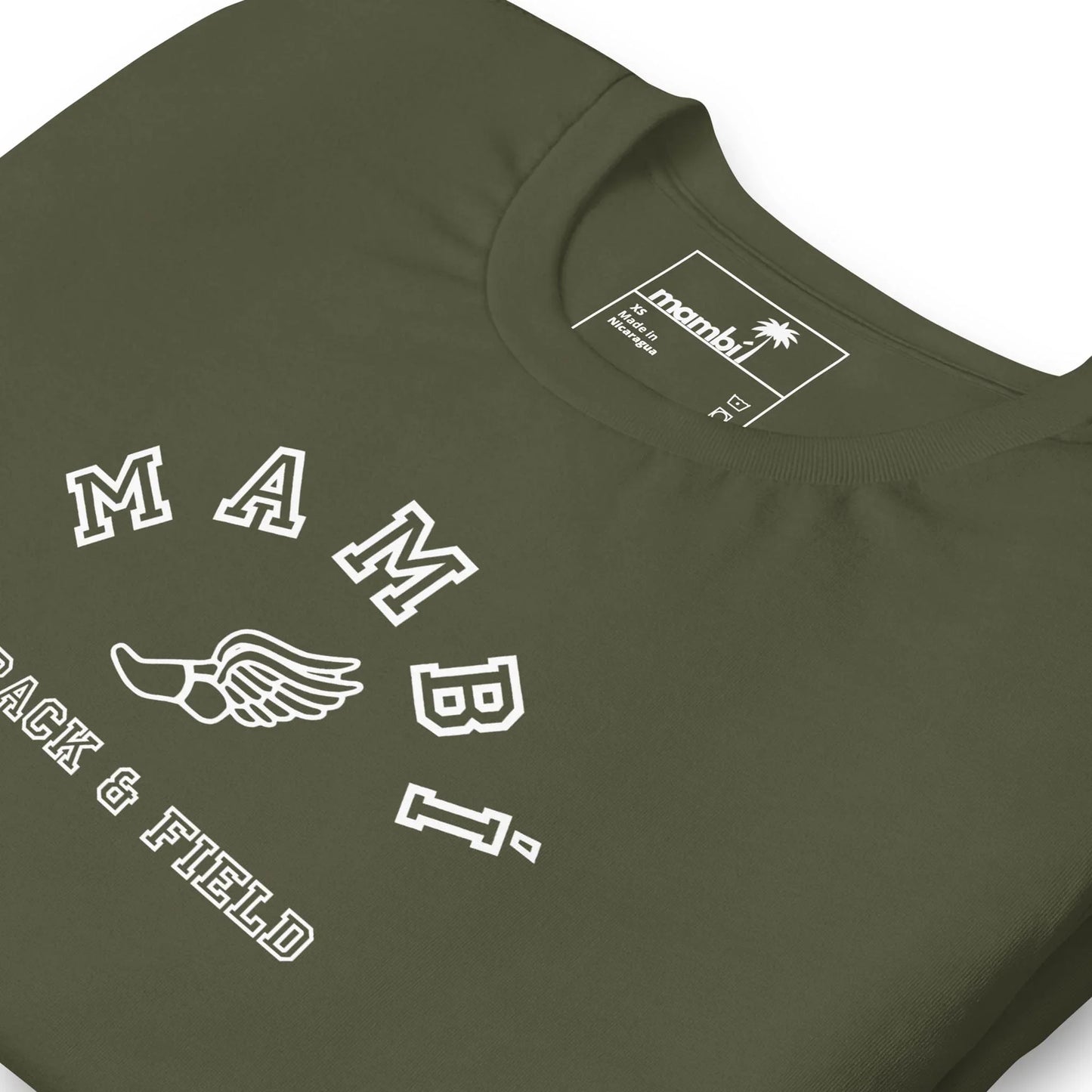 A close-up of an olive green Mambí t-shirt featuring the text MAMBI above a winged foot graphic and TRACK & FIELD underneath. The inside label shows the brand name mambi with a palm tree logo.