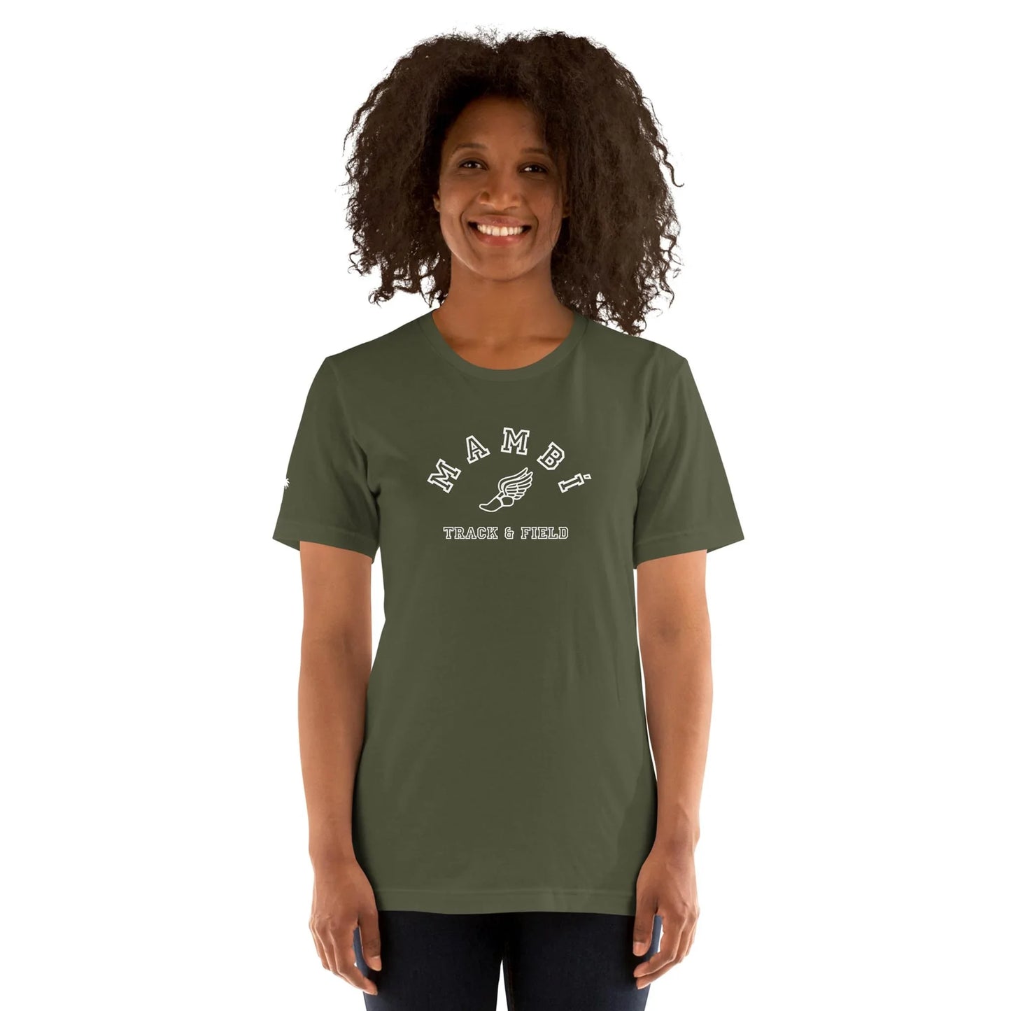 A smiling woman with curly hair wears an olive green Mambí TRACK & FIELD T-shirt featuring a graphic of a winged shoe, standing against a plain white background.