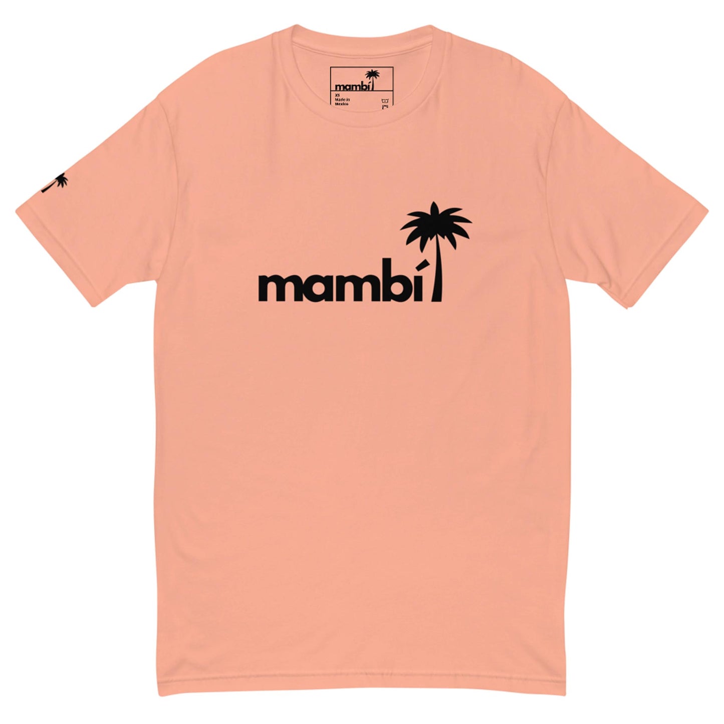 A pale pink t-shirt featuring the word Mambí in bold black letters, with a black palm tree graphic replacing the dot over the i. A smaller palm tree logo appears on the left sleeve.