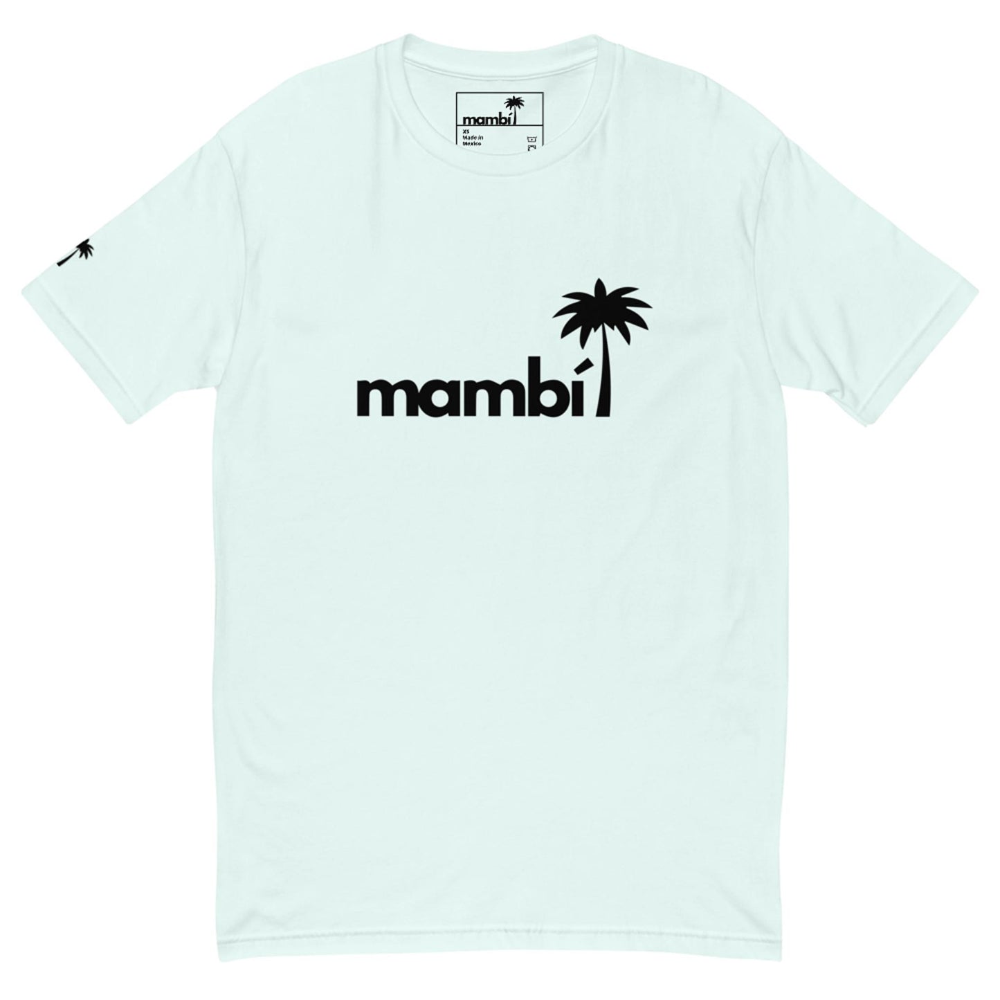 Light-colored Mambí t-shirt featuring the word “mambi” in bold black letters, with a black palm tree graphic as the letter “i.” A smaller palm tree icon is on the left sleeve near the shoulder.