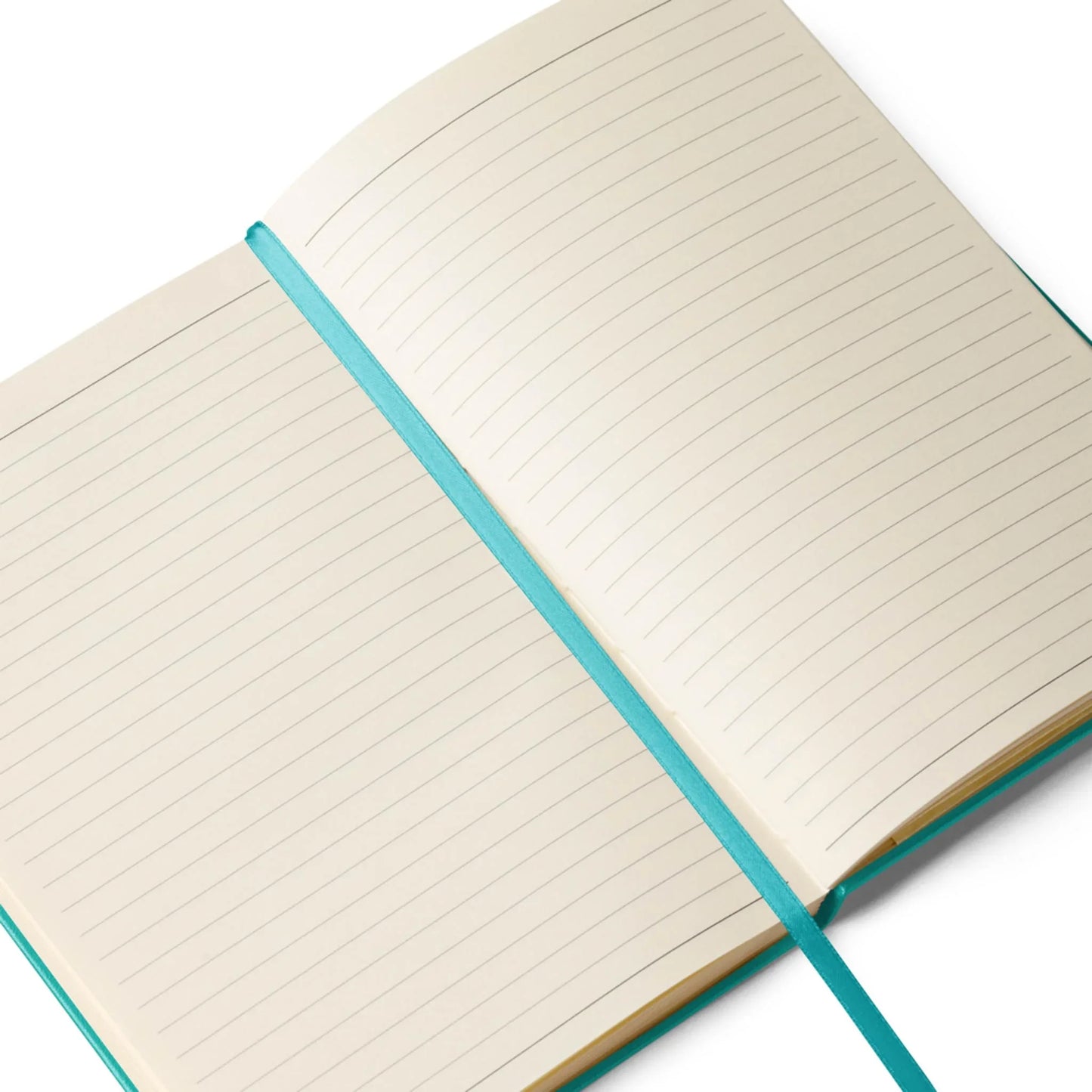 An open lined Mambí notebook with cream-colored pages and a teal ribbon bookmark laid across the center. The pages are blank and ready for writing.
