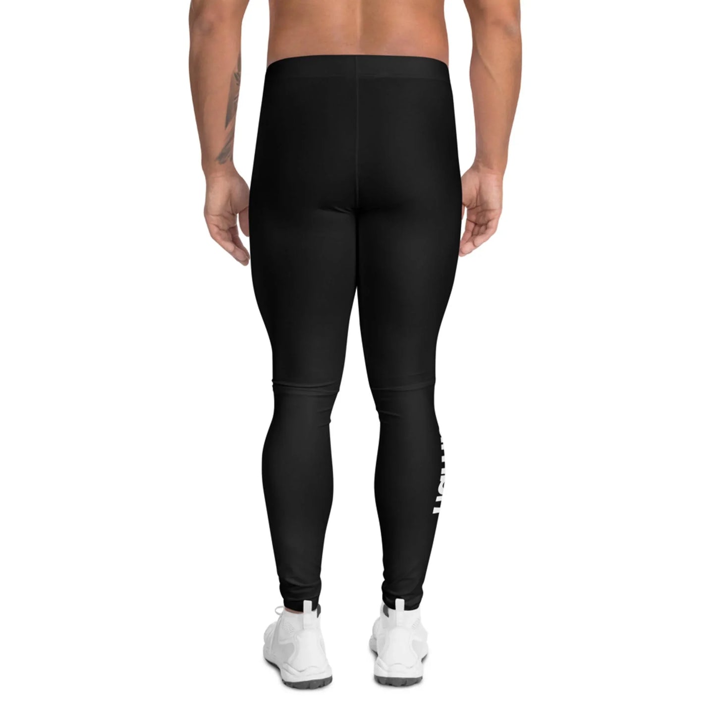 A person stands with their back to the camera, wearing Mambí black leggings and white athletic shoes against a plain white background.