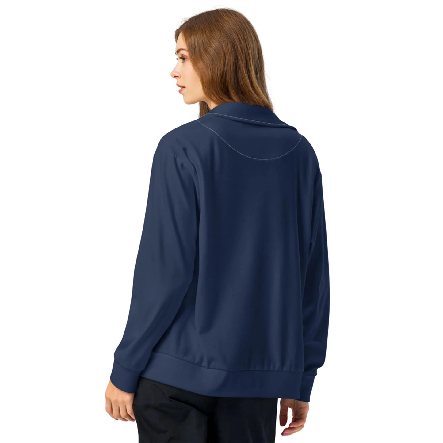 A woman with long brown hair is shown from the back, wearing a navy blue Mambí jacket and black pants, standing against a plain white background.