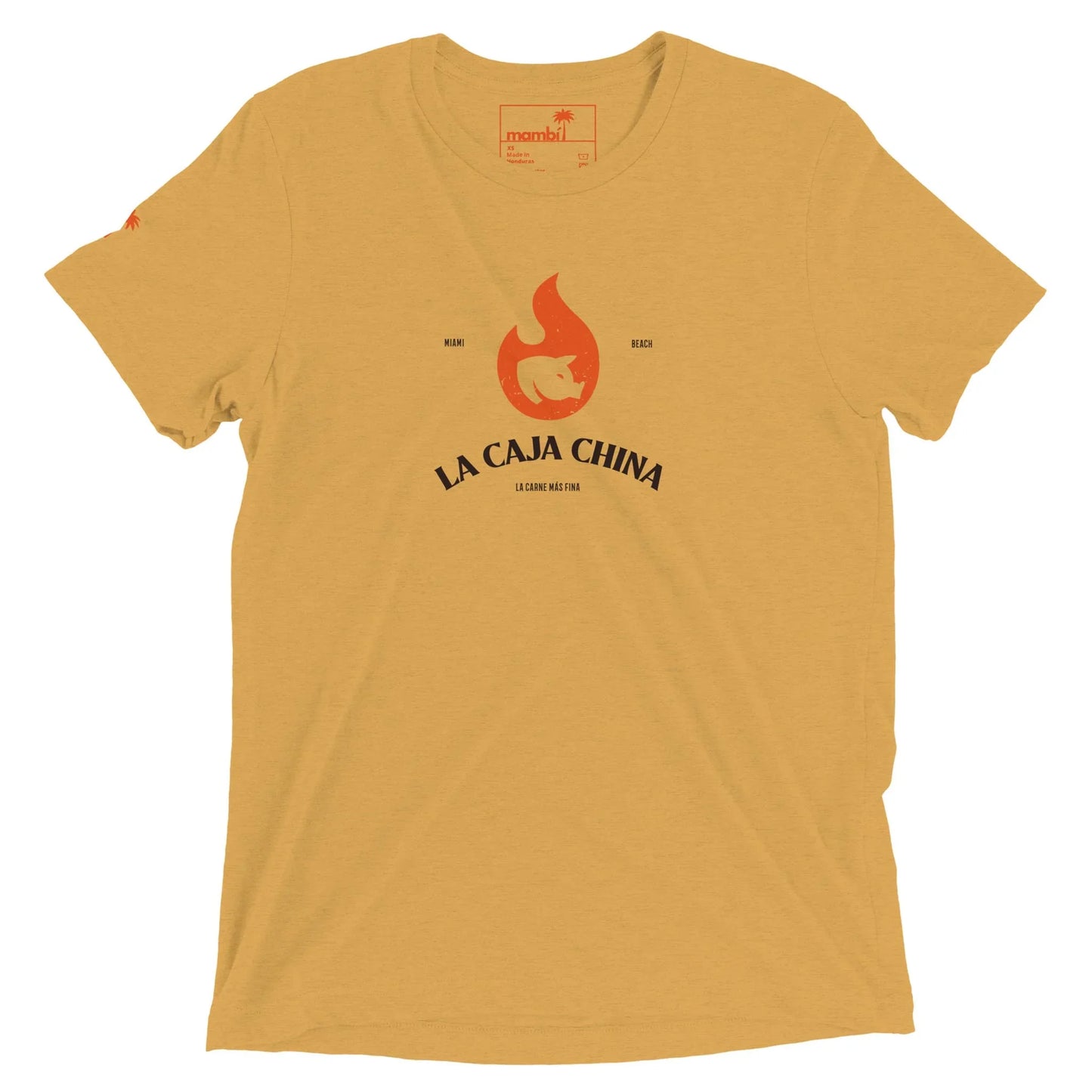 A mustard yellow t-shirt featuring a stylized red flame with a pig silhouette inside and the words LA CAJA CHINA, Mambí, and A Cuban New Thing printed beneath the flame.